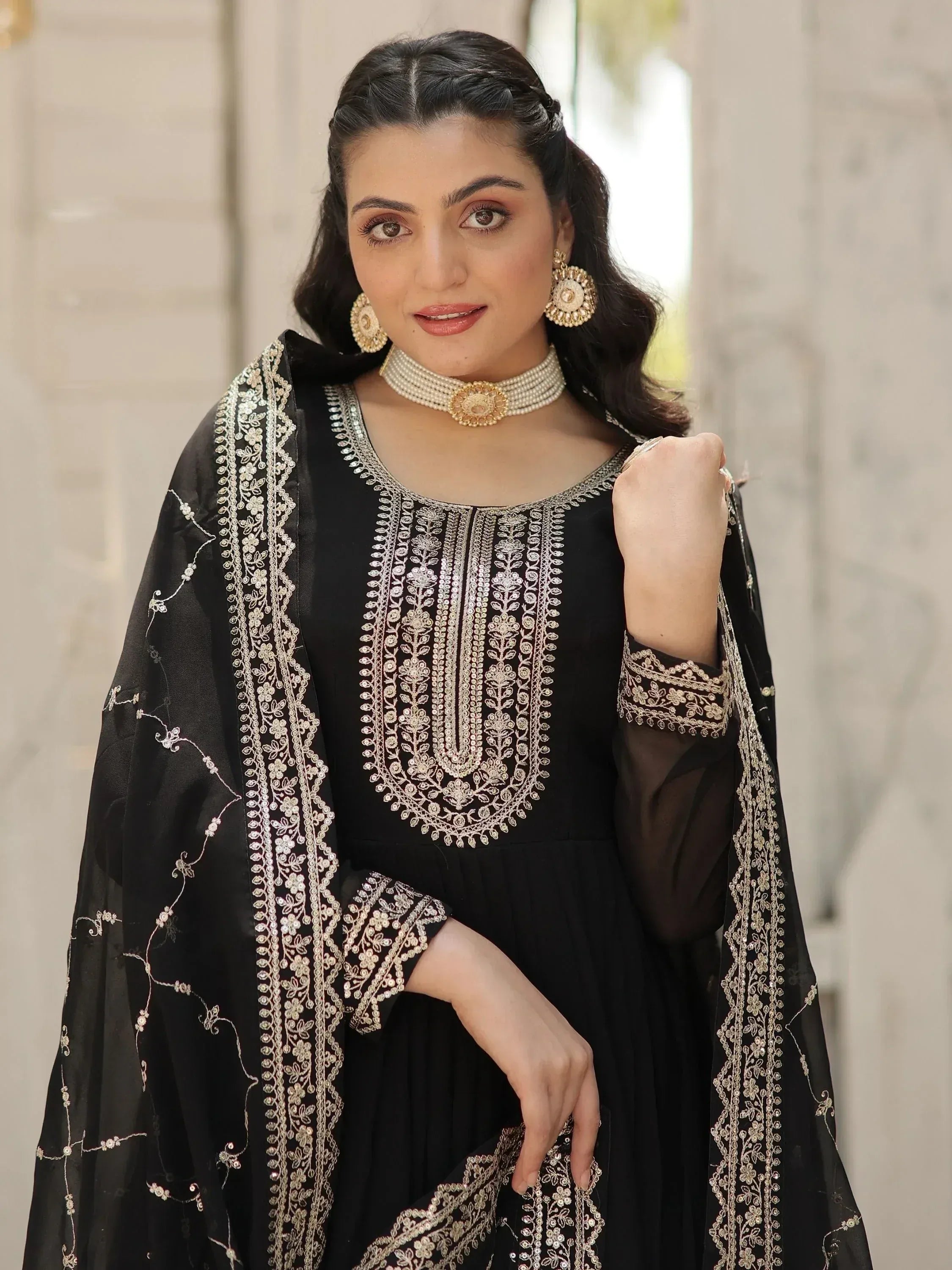 Black embroidered ethnic gown with gold detailing, perfect for Indian festive occasions and weddings.