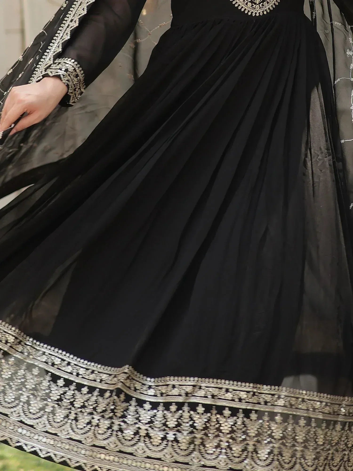 Black ethnic gown with silver embroidery, pleated skirt, and sheer sleeves for Indian wear