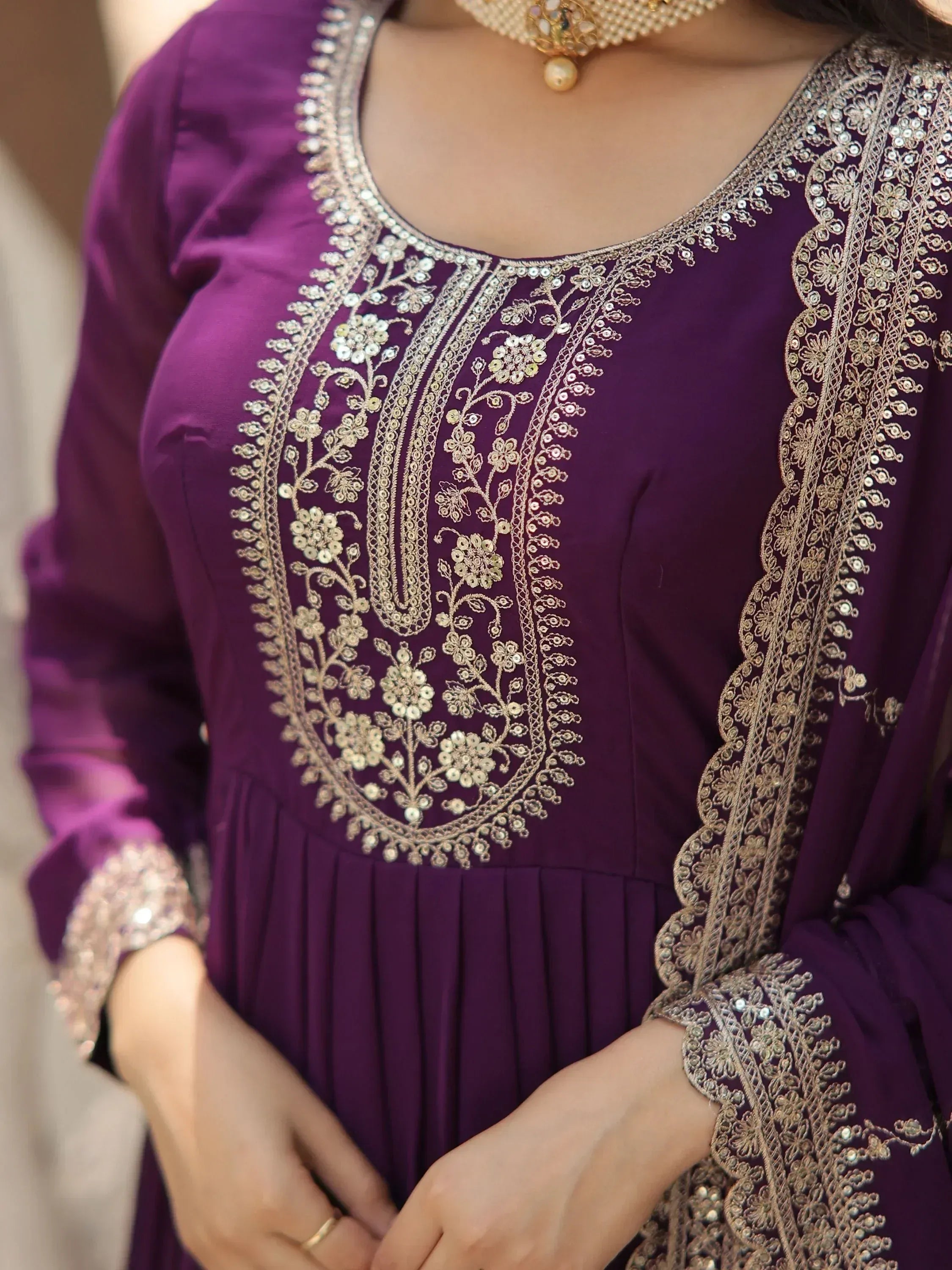 Purple ethnic gown with gold floral embroidery and sequins, perfect for Indian weddings and parties.