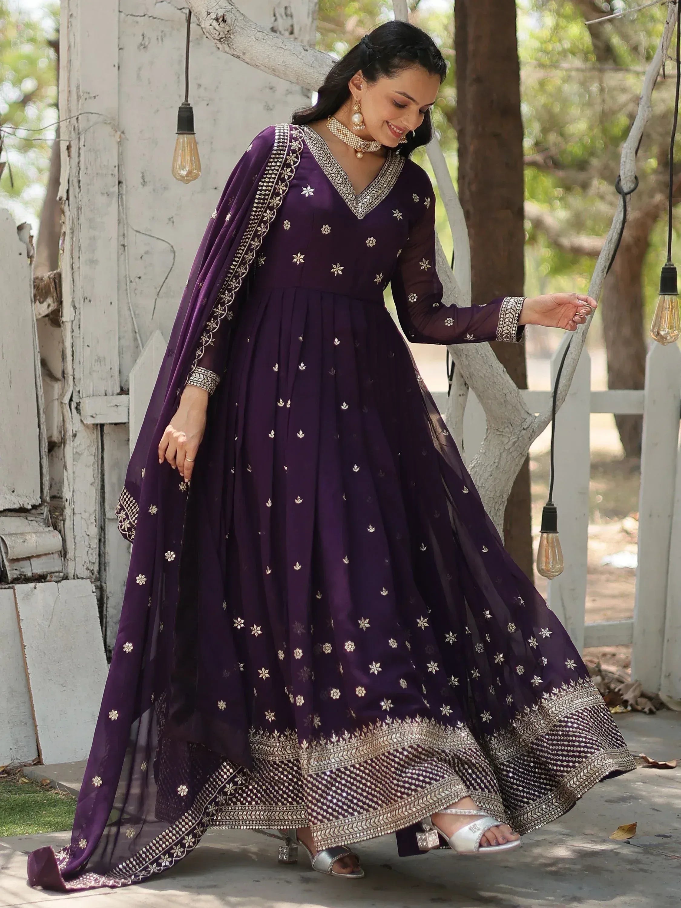 Elegant purple ethnic gown with gold embroidery, perfect for Indian festive occasions and weddings.