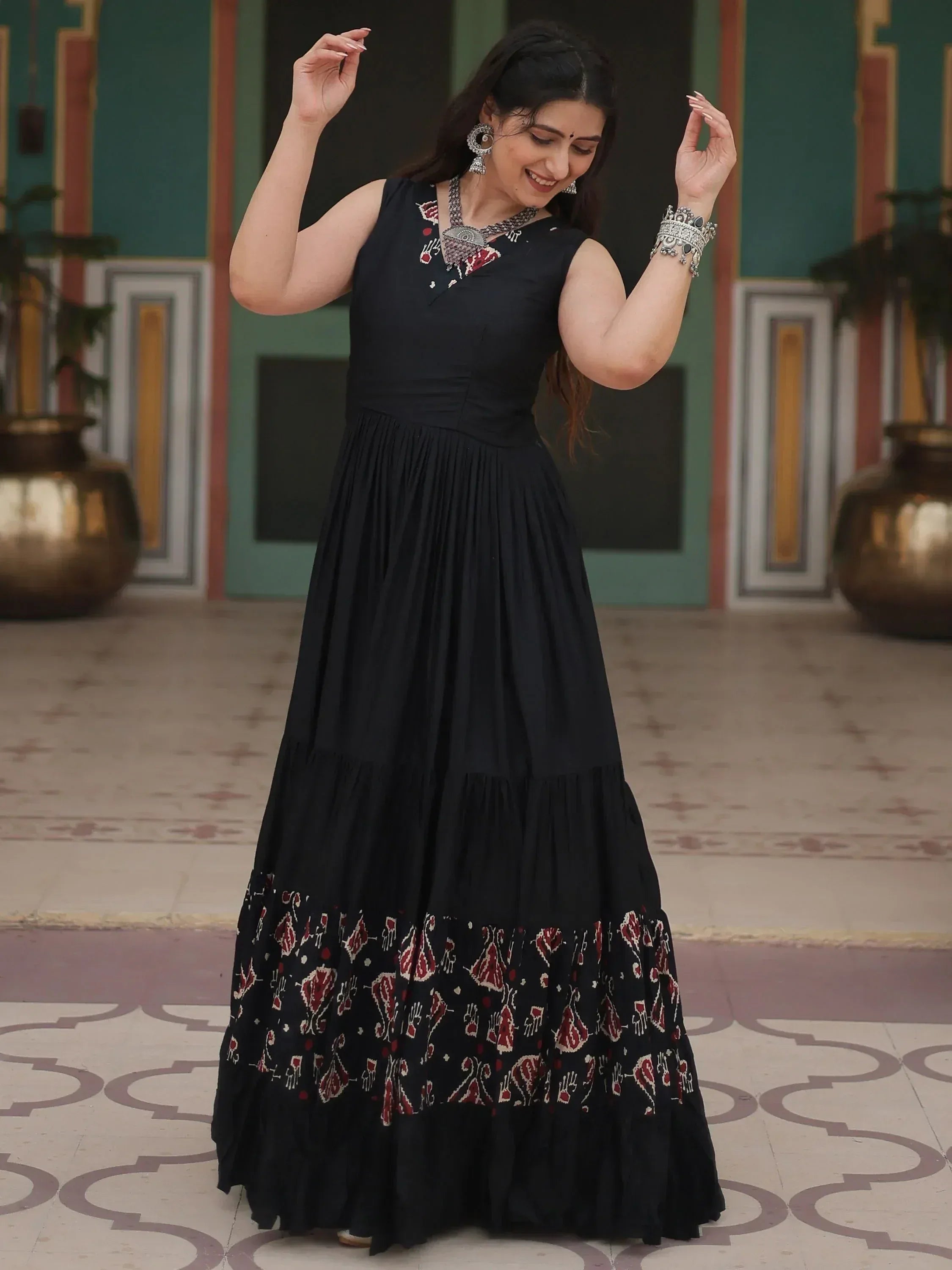Black ethnic gown with red floral embroidery, perfect for Indian occasions and festive wear.