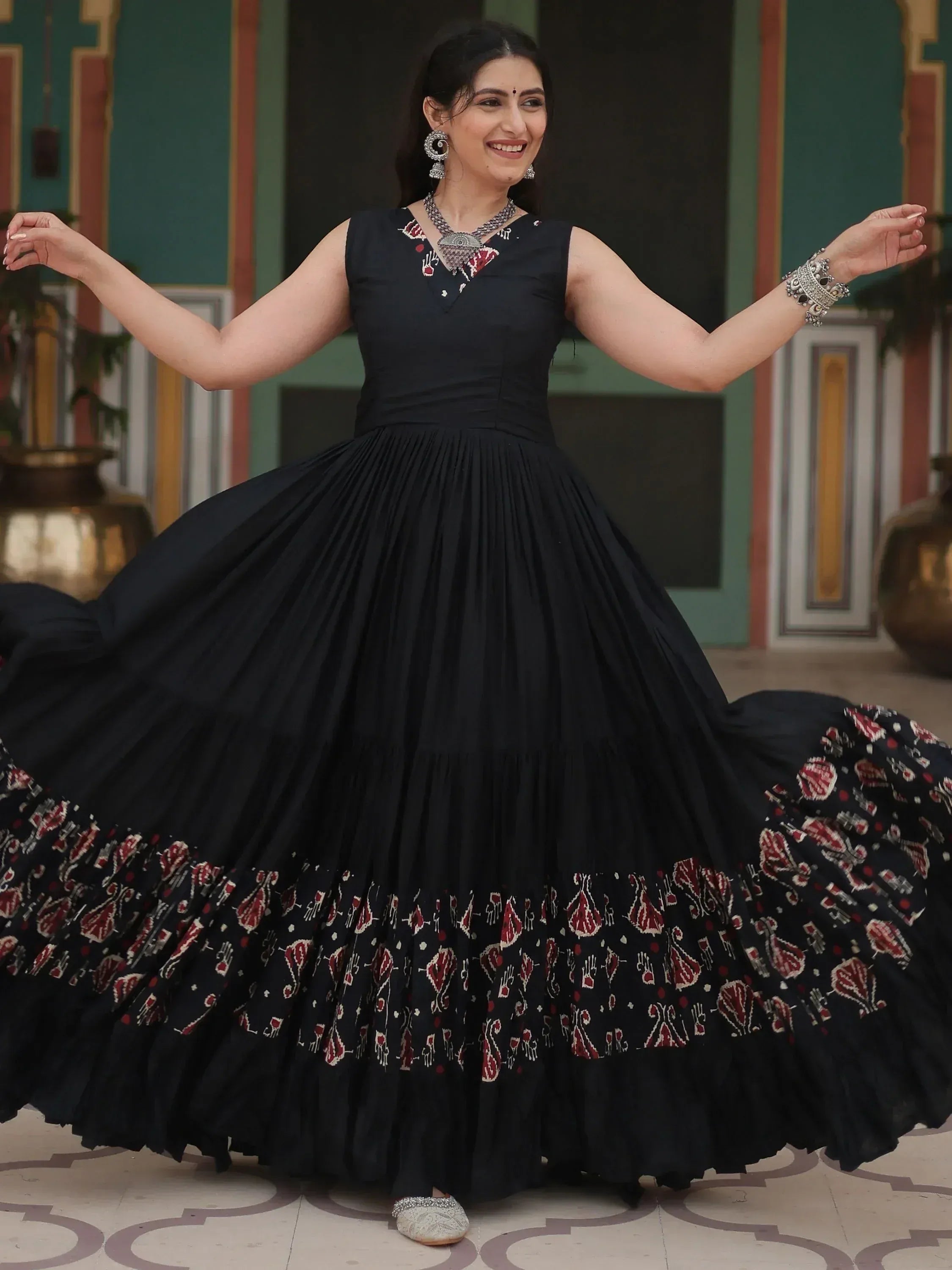 Black ethnic gown with red and white printed border, perfect for Indian occasions and festive wear.