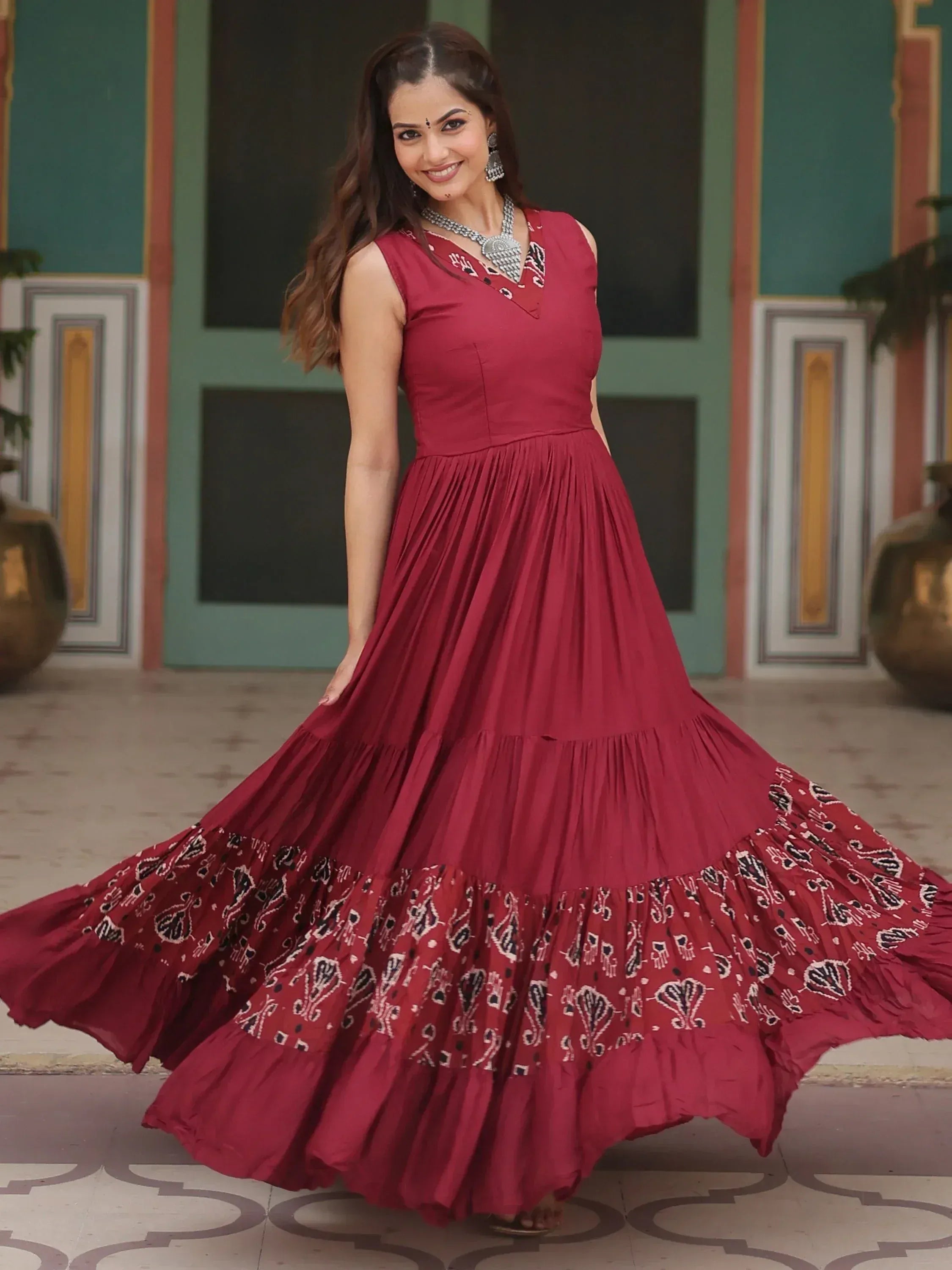 Maroon ethnic gown with printed tiered skirt, perfect for Indian festive occasions
