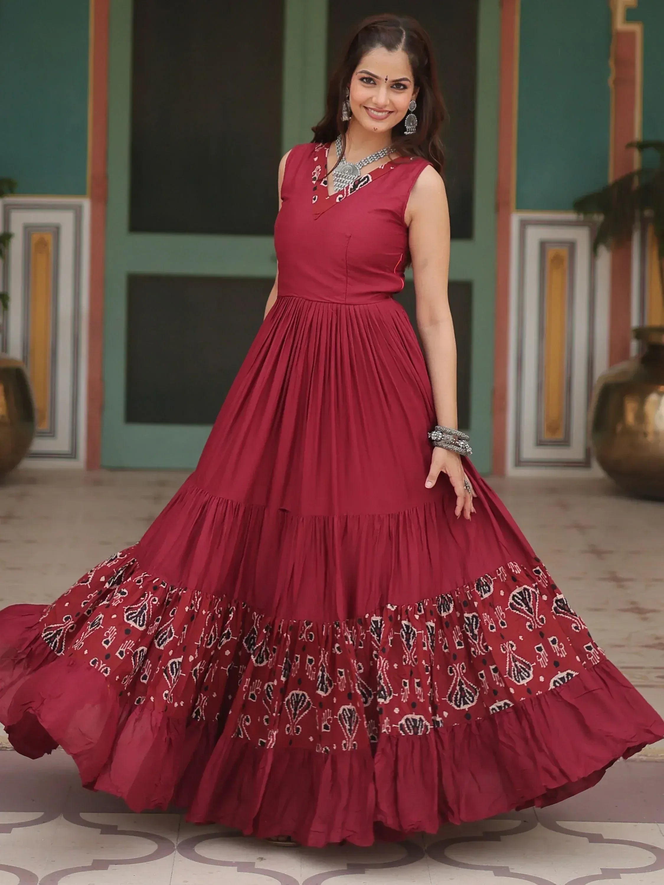 Maroon ethnic gown with printed tiered skirt, perfect for Indian occasions and festive wear