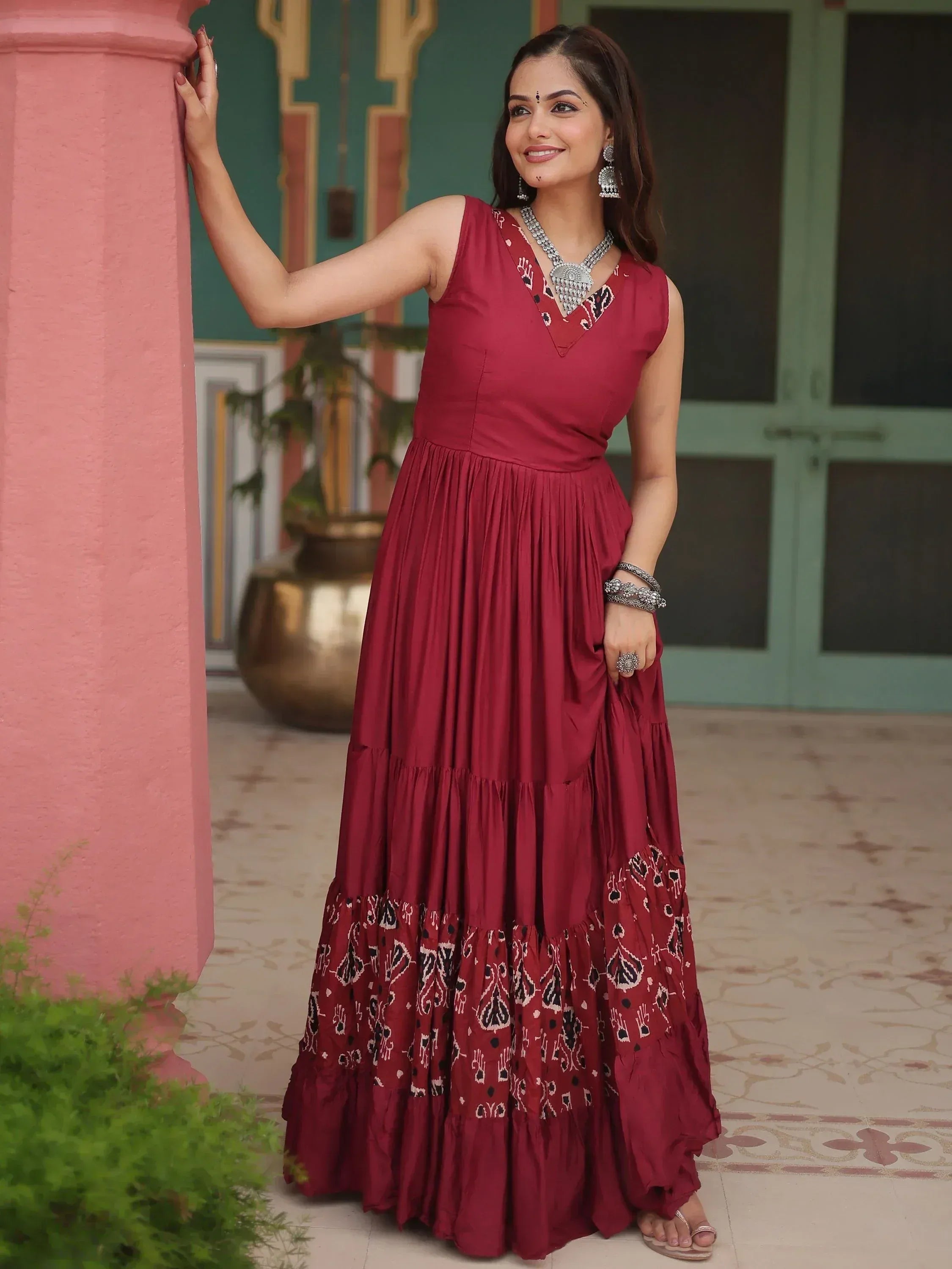Maroon ethnic gown with printed tiers, perfect for Indian occasions and festive wear.