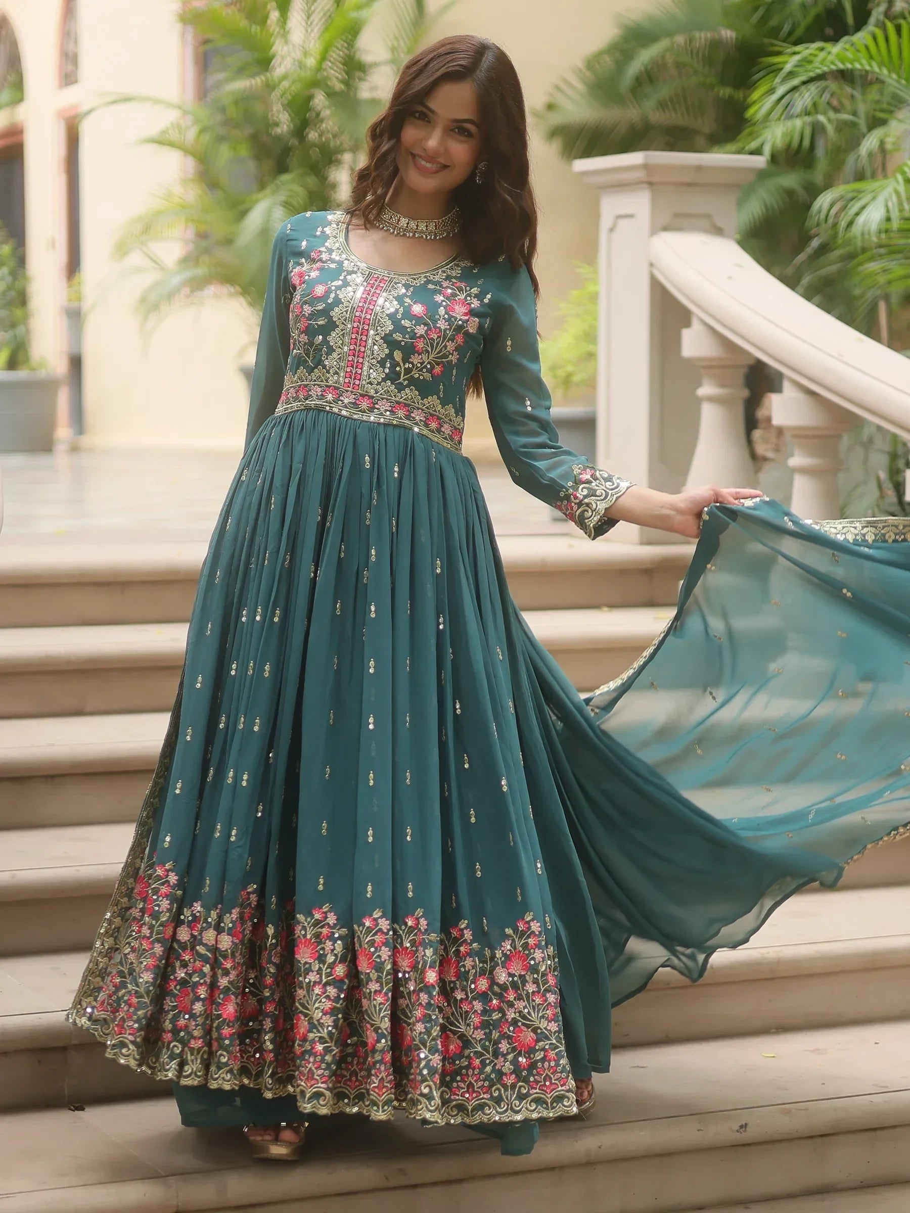 Woman wearing teal floral embroidered Anarkali gown with dupatta, Indian ethnic wear