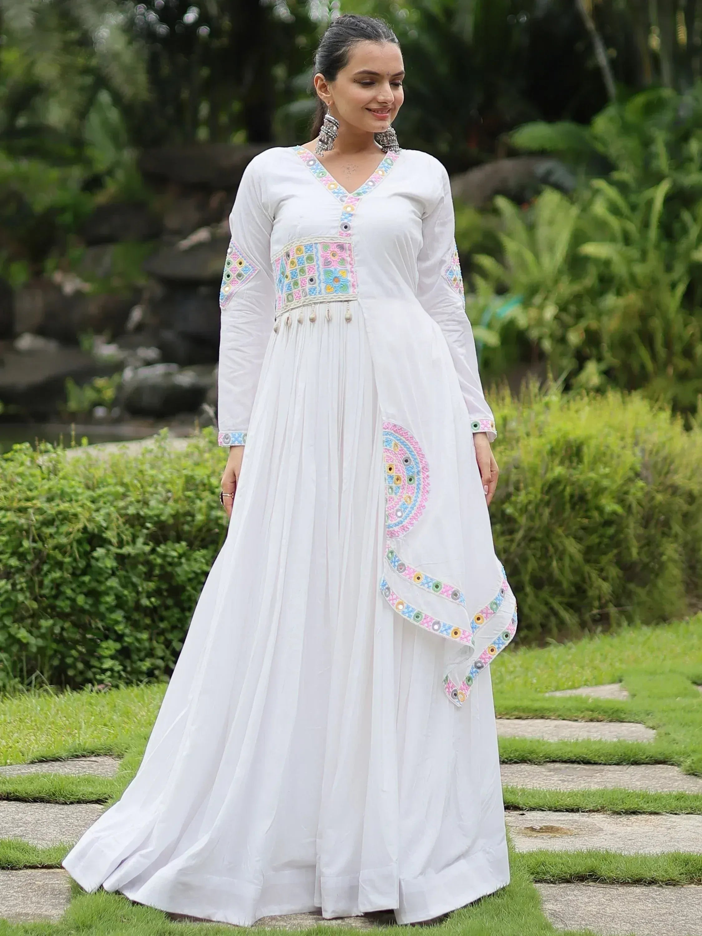 White ethnic gown with colorful mirror work, perfect for Indian occasions and festive wear.