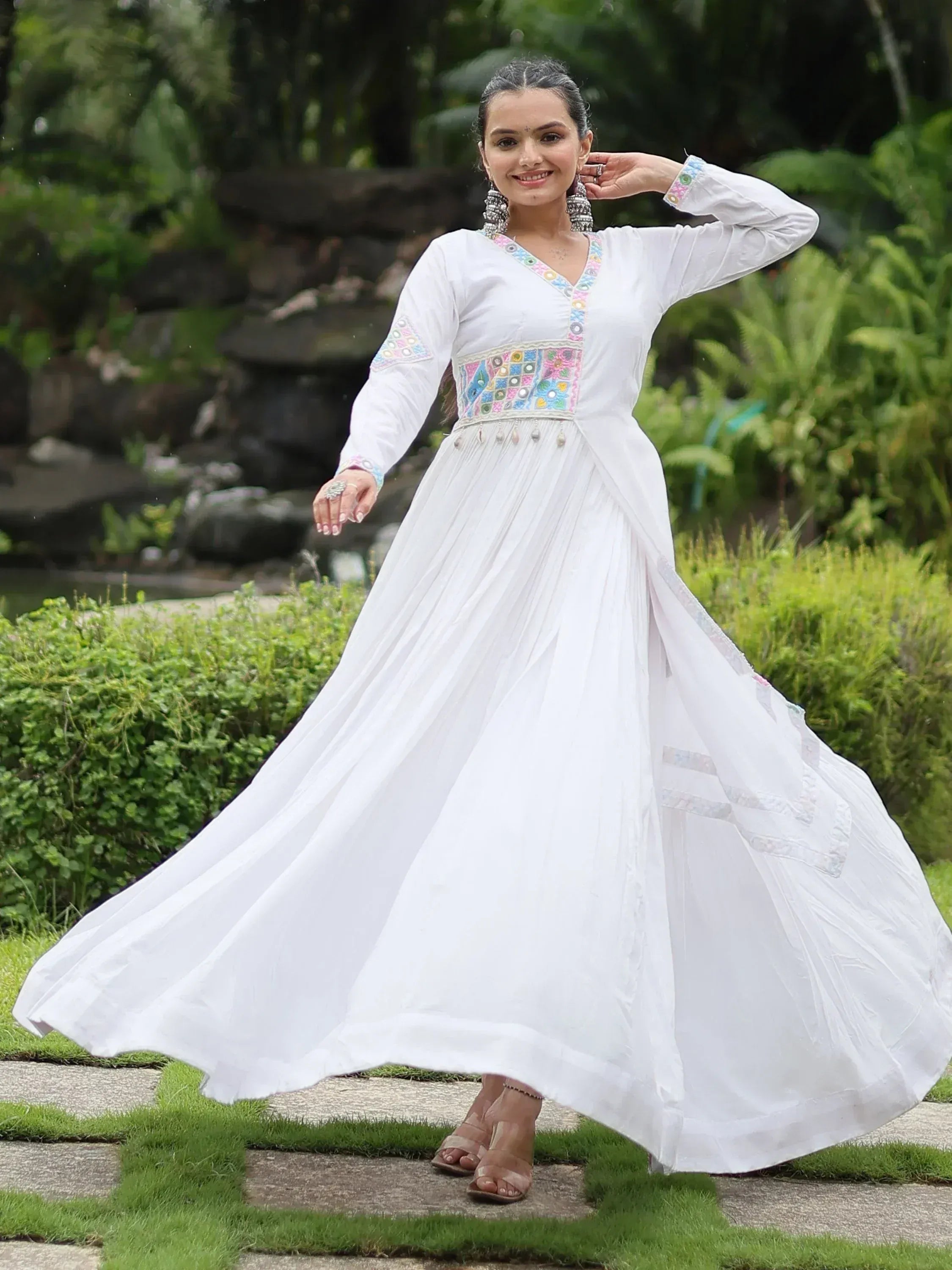 White ethnic gown with colorful mirror work, perfect for Indian occasions and festive wear.