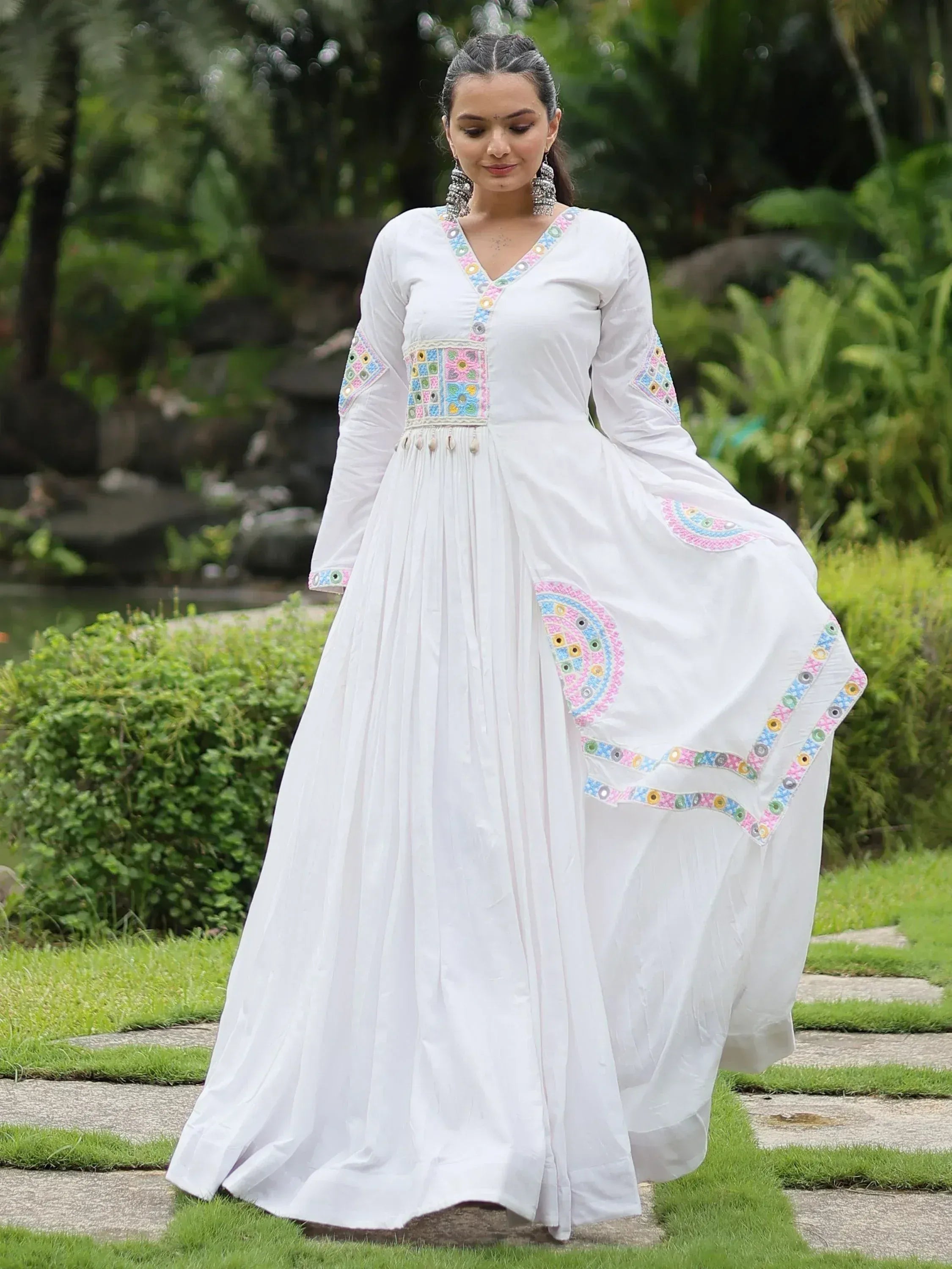 White ethnic gown with colorful mirror embroidery, perfect for Indian festive occasions