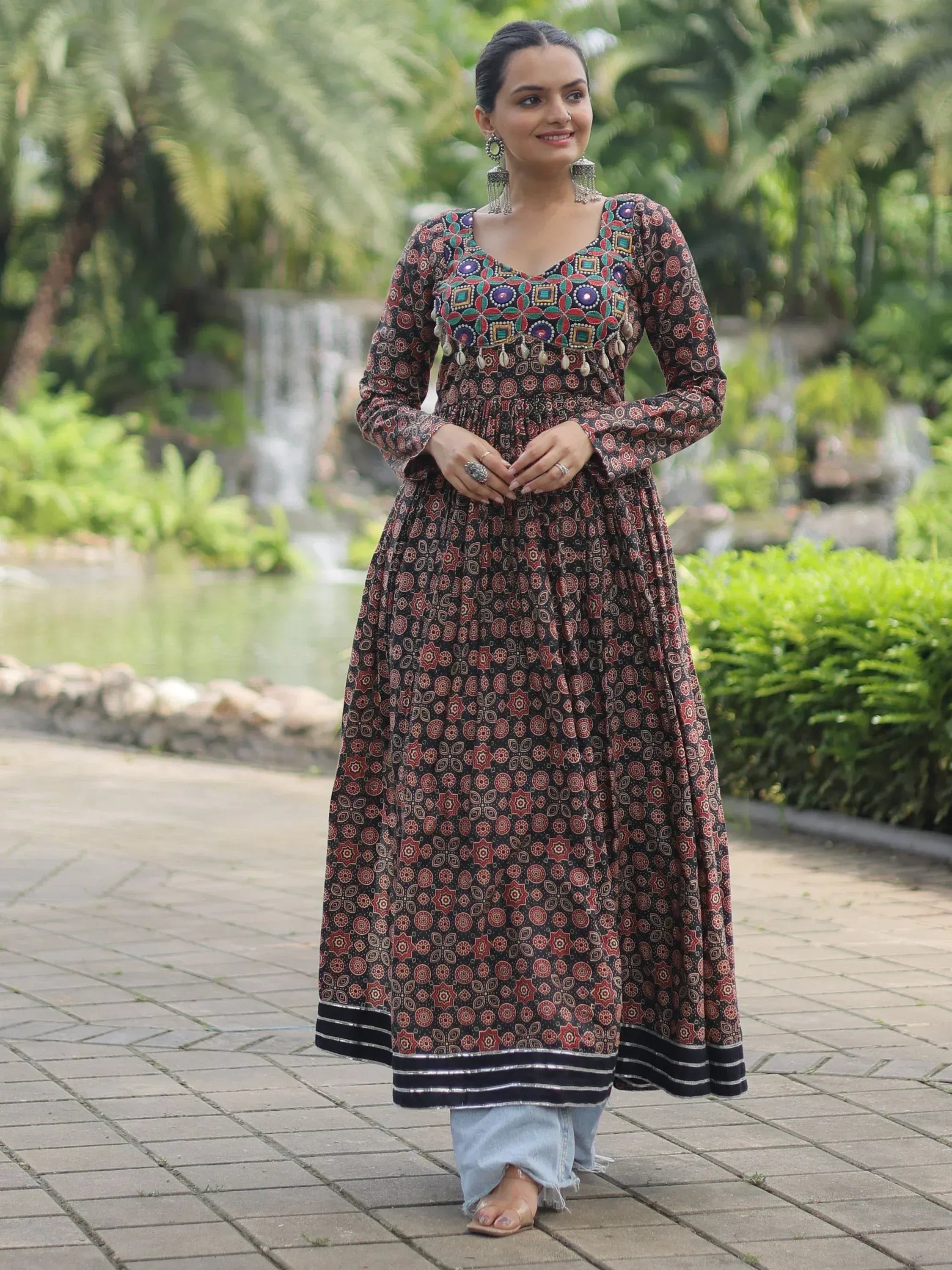 Woman in printed ethnic anarkali gown with mirror work, styled with jeans for casual wear