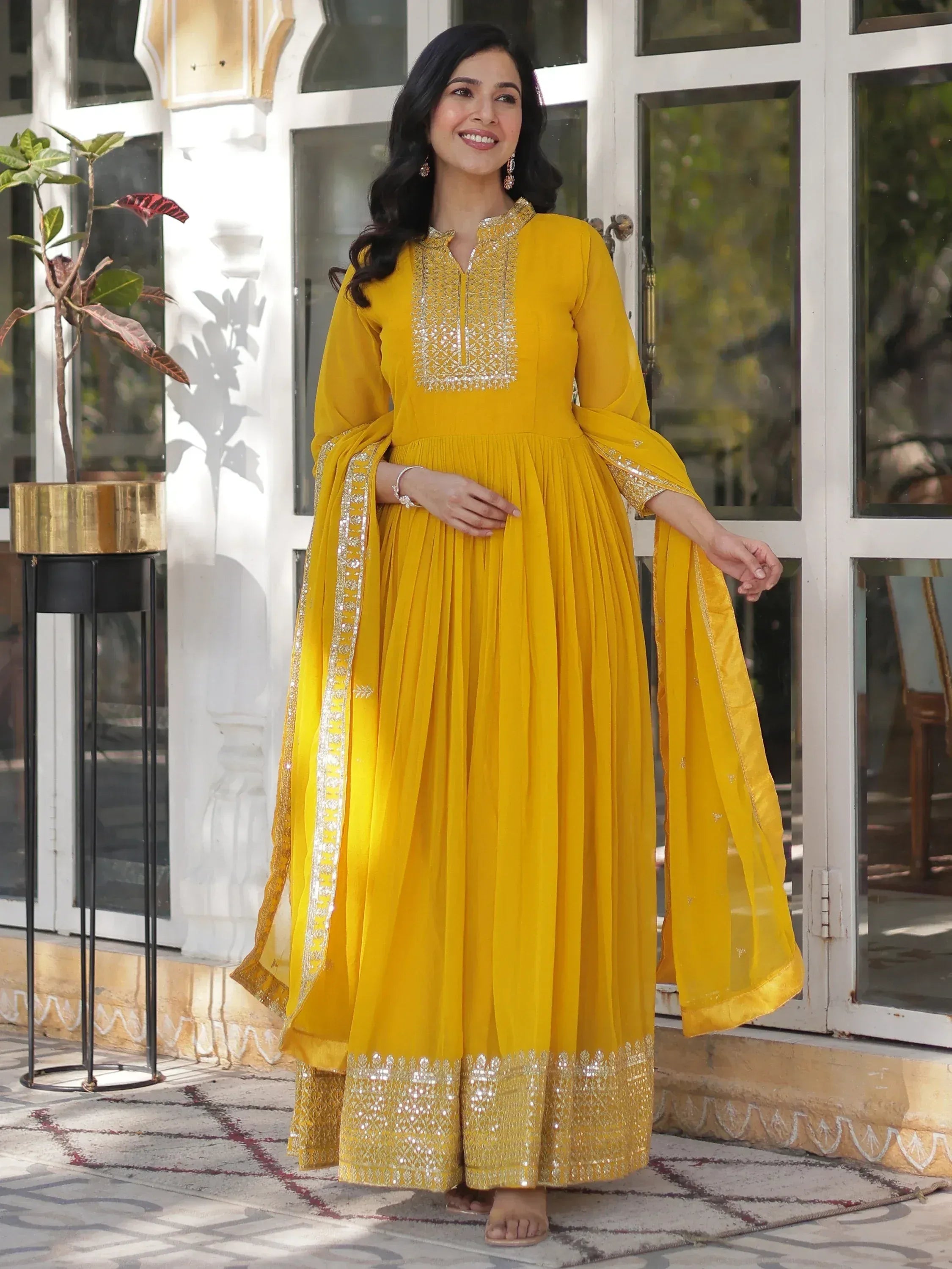 Yellow ethnic gown with silver embroidery, perfect for festive occasions