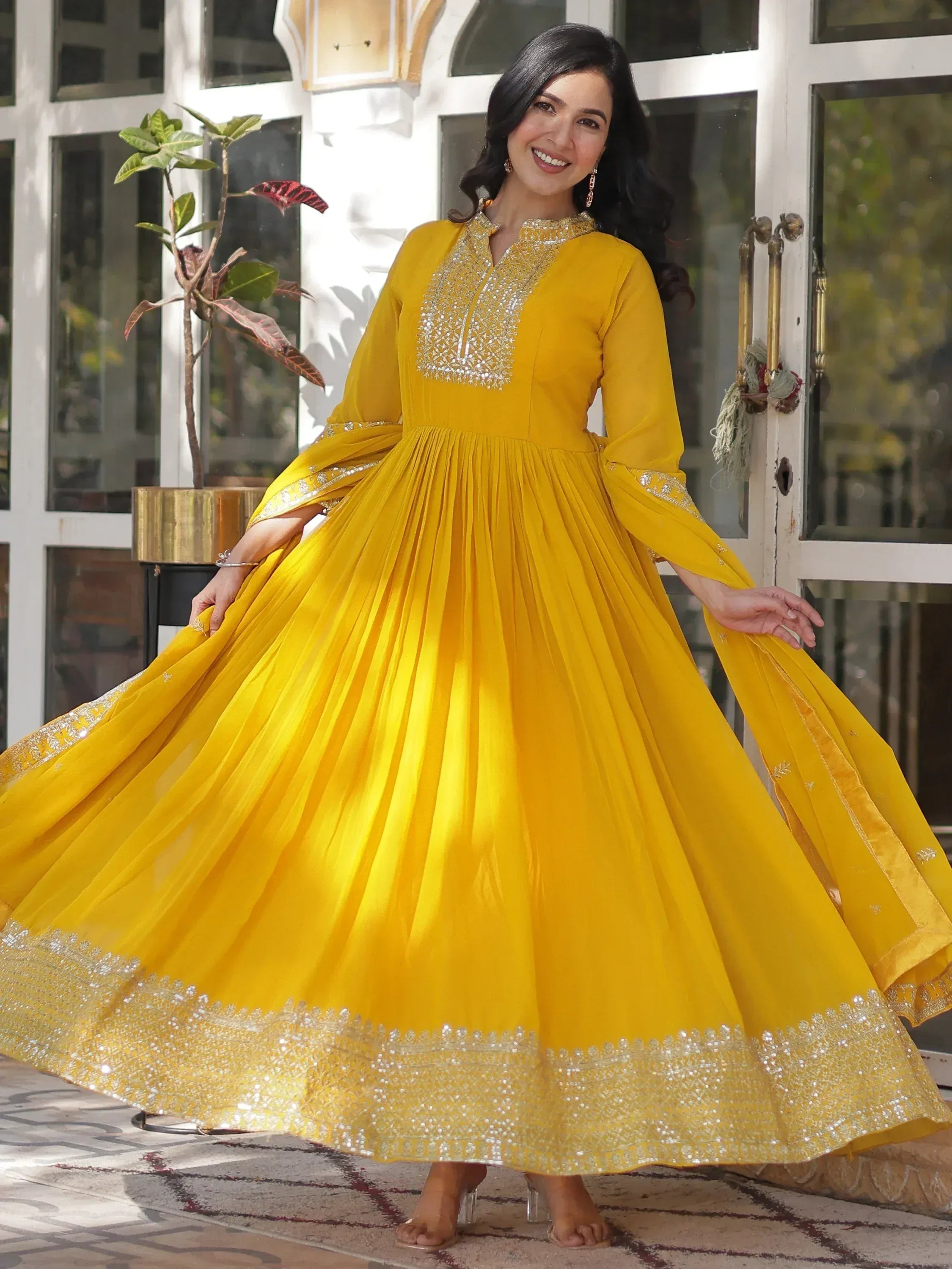 Yellow ethnic gown with silver embroidery, perfect for festive occasions and celebrations.