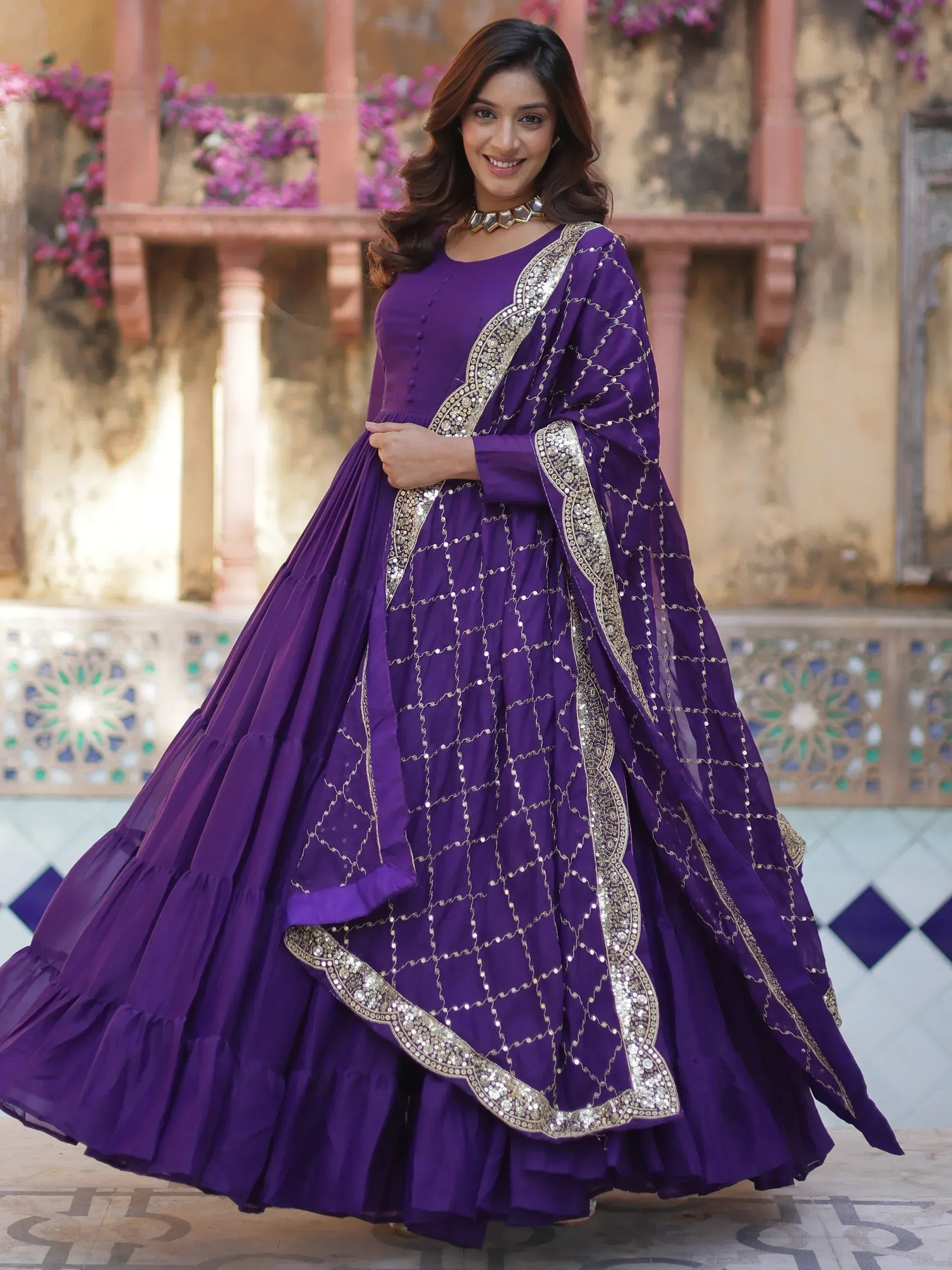 Purple ethnic gown with gold embroidery and mirror work, perfect for Indian weddings and festive occasions