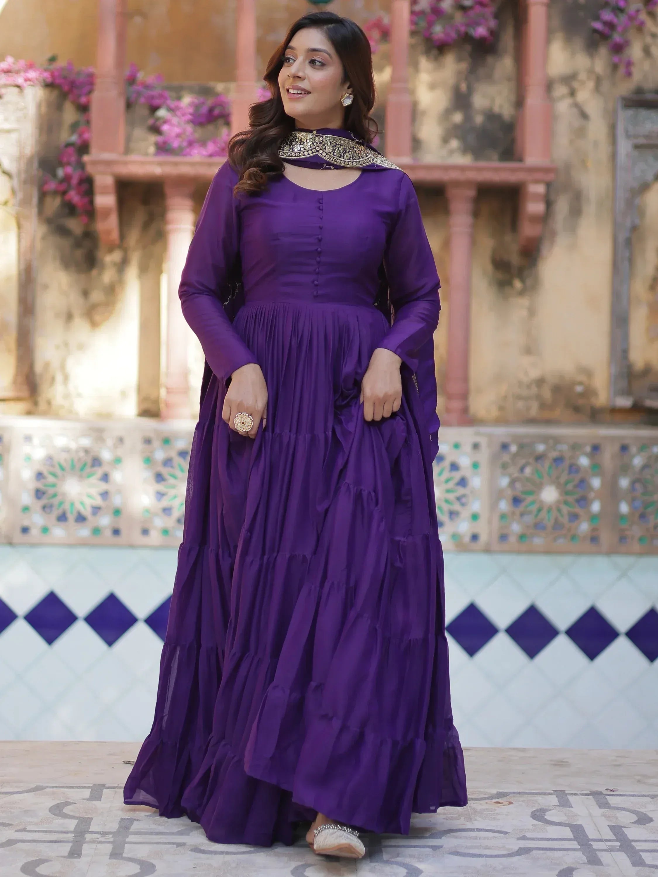 Purple ethnic gown with gold embellished neckline, perfect for Indian occasions and festive wear.