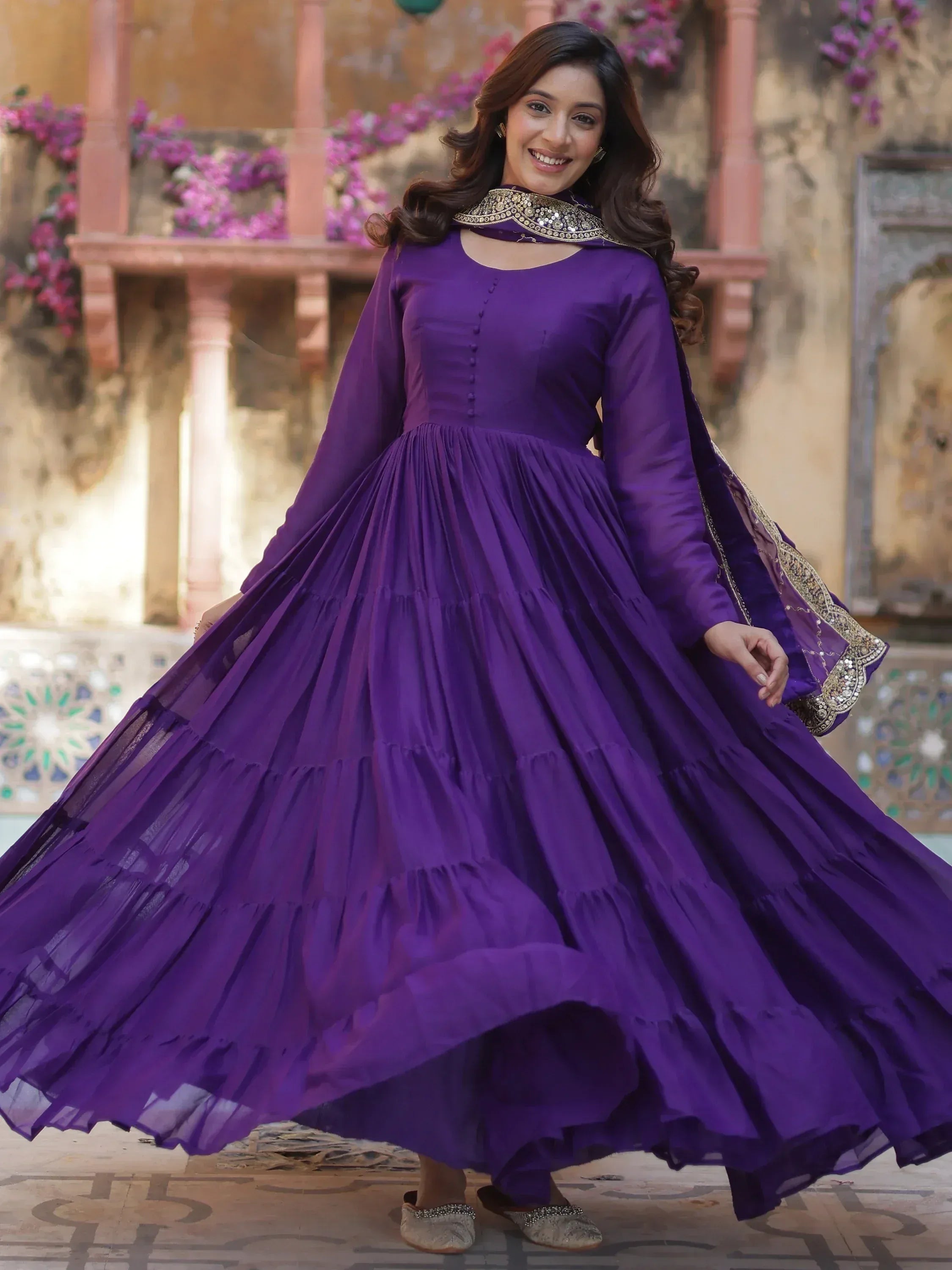 Woman in purple ethnic gown with embellished cape, perfect for Indian festive occasions