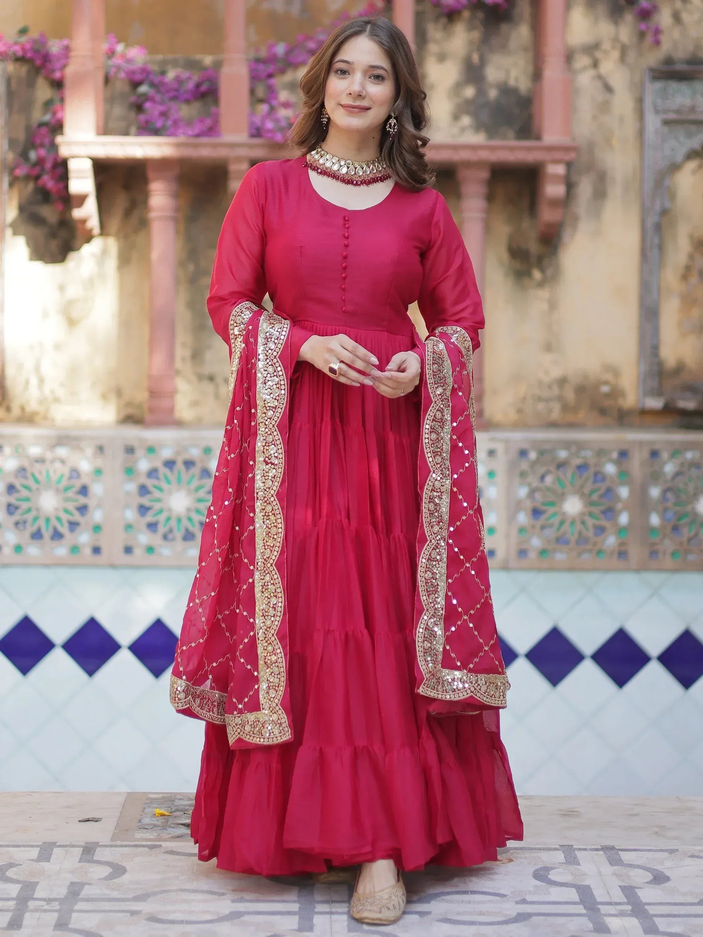 Red ethnic gown with gold embroidery, perfect for Indian occasions and festive wear.