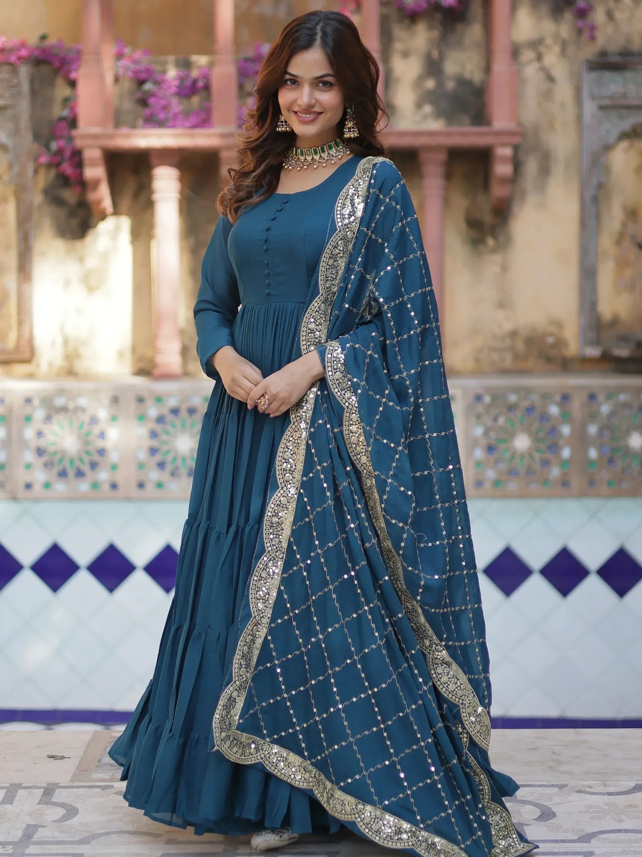 Teal blue ethnic gown with gold sequin embroidery, perfect for Indian weddings and festive occasions