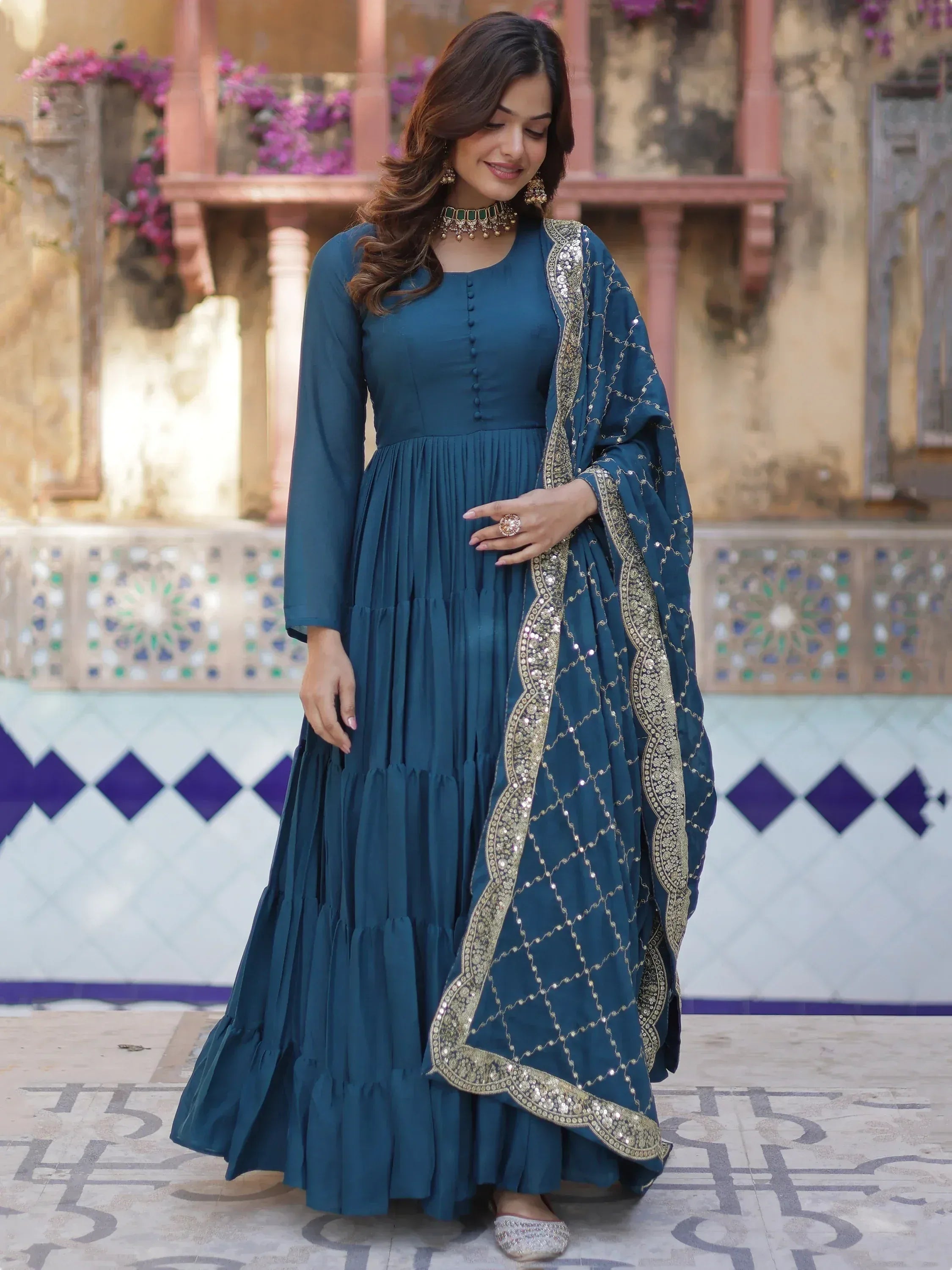 Teal ethnic gown with gold embroidery, perfect for Indian weddings or festive occasions