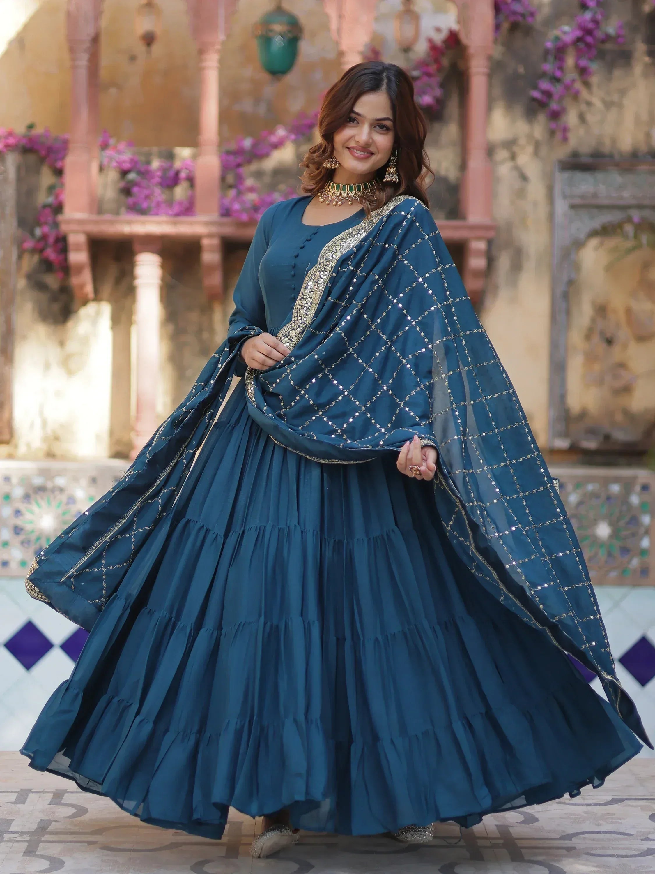 Teal blue ethnic anarkali suit with gold embroidery and sequin dupatta, perfect for Indian occasions