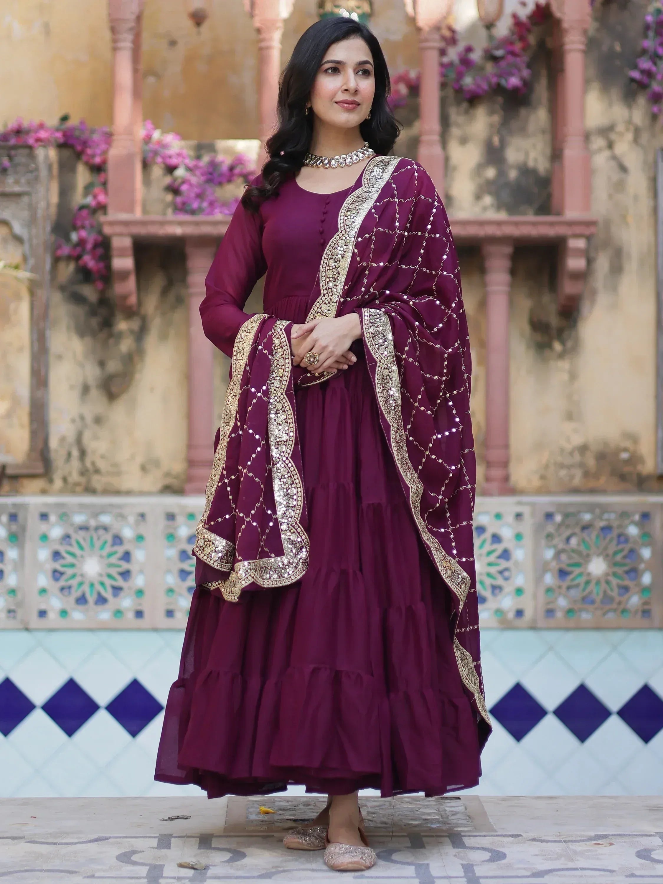 Elegant maroon Indian ethnic gown with gold embroidery, perfect for festive occasions and weddings.