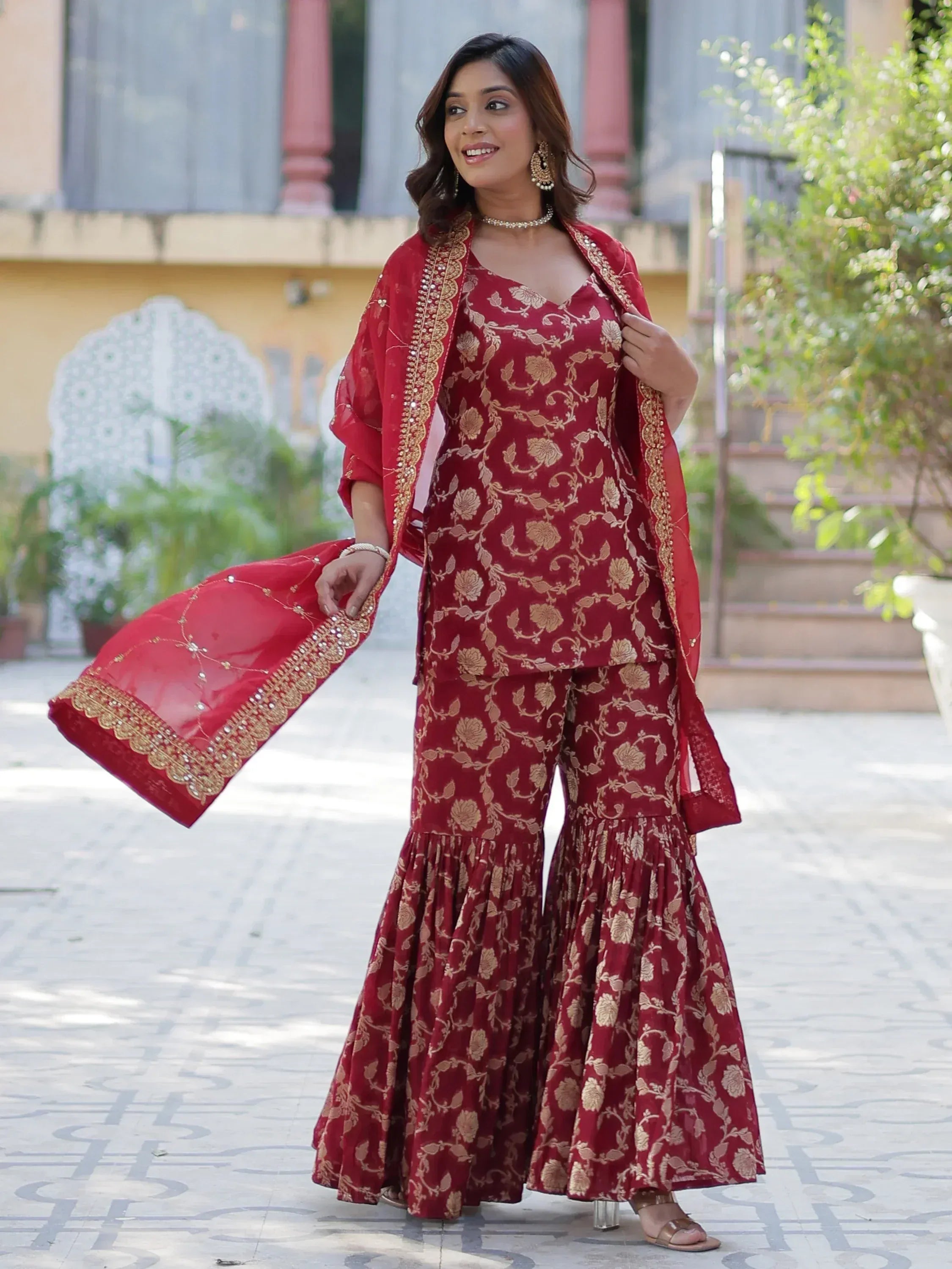 Red floral print palazzo suit with gold embroidery and dupatta, perfect for Indian ethnic occasions