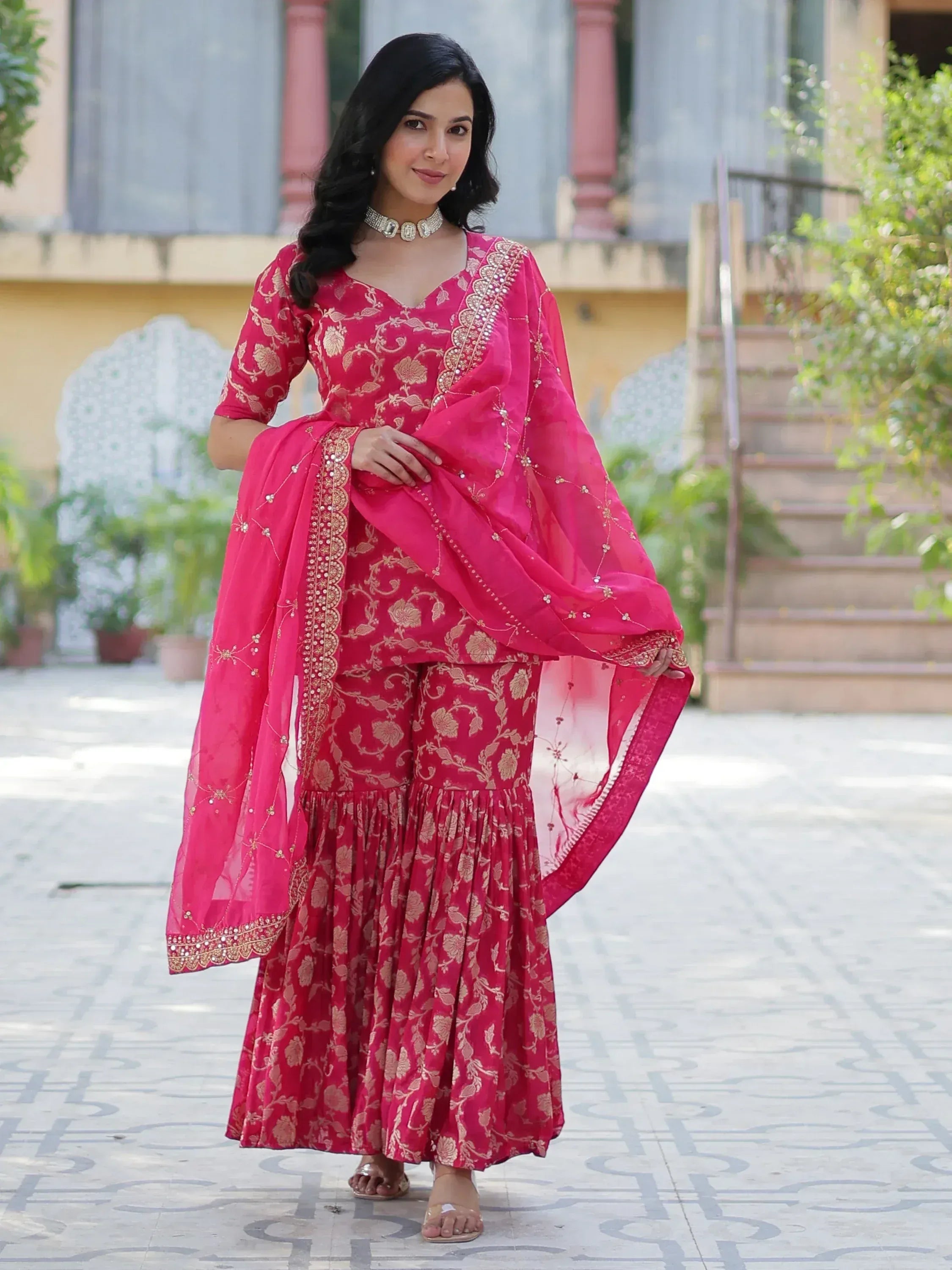 Pink floral printed sharara suit with gold embroidery and dupatta, ideal for Indian ethnic occasions