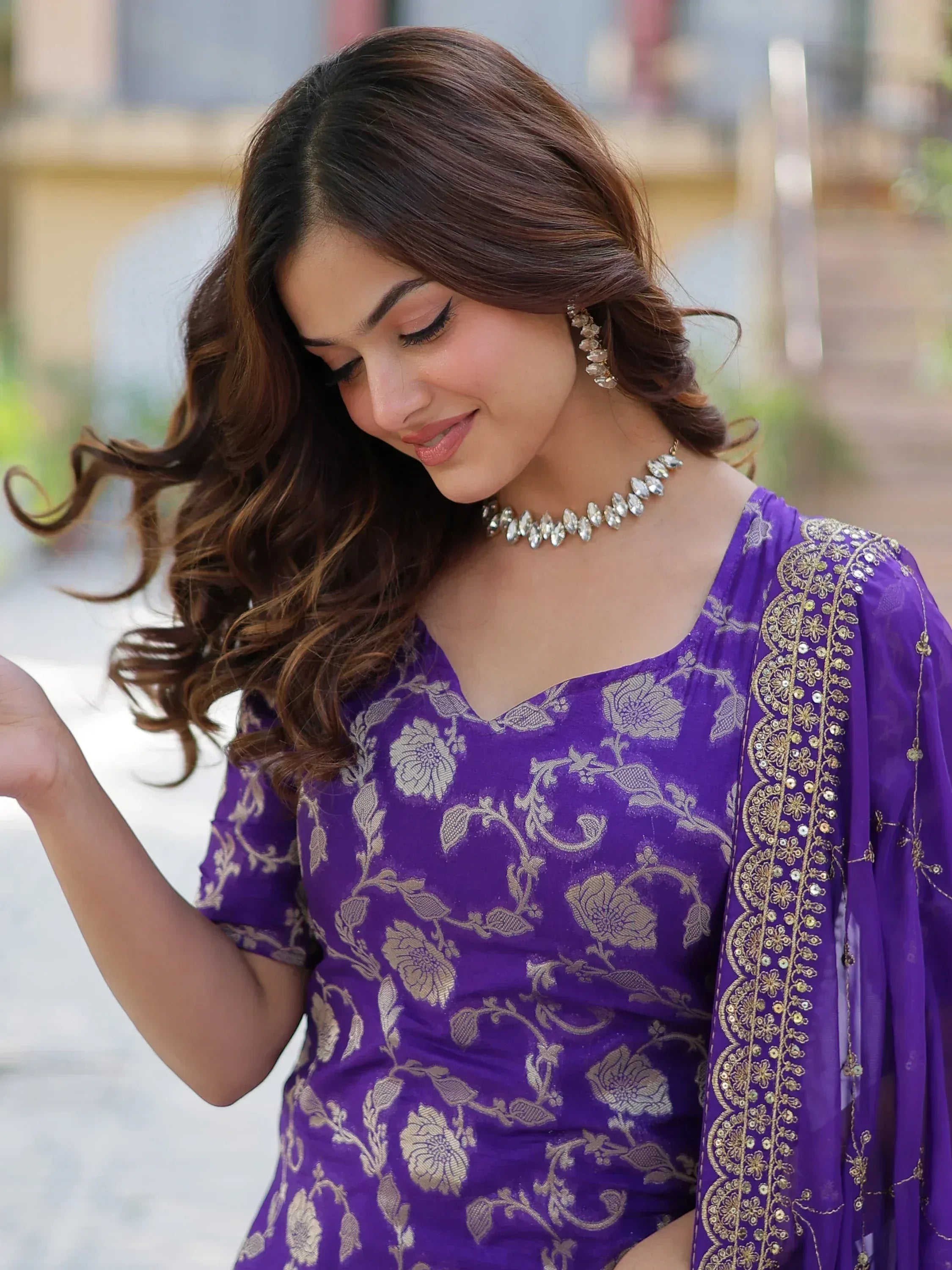 Purple floral embroidered ethnic kurta with gold detailing and matching dupatta, styled with statement jewelry