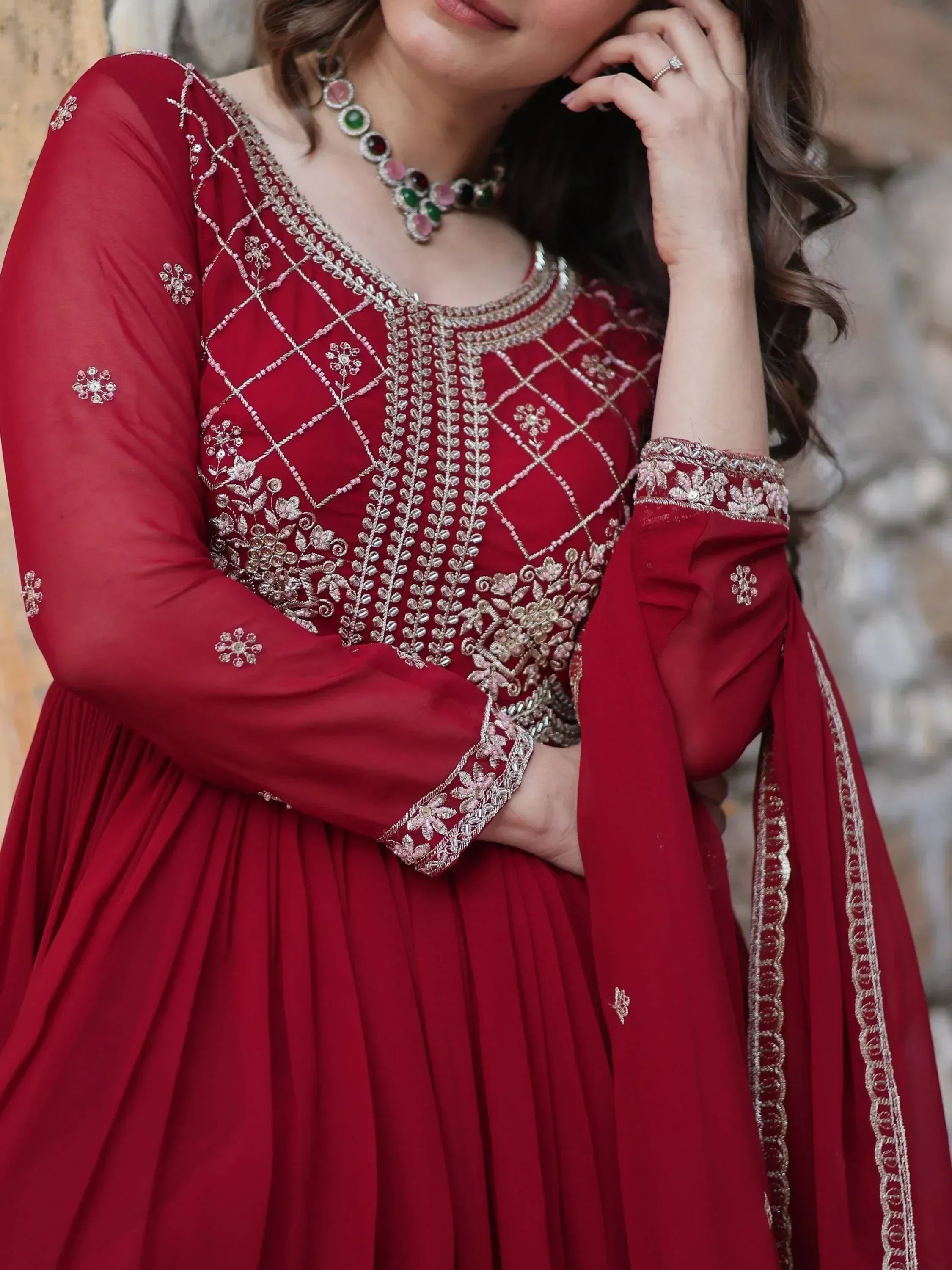 Red ethnic anarkali with silver embroidery, floral motifs, and pleated skirt for Indian occasions