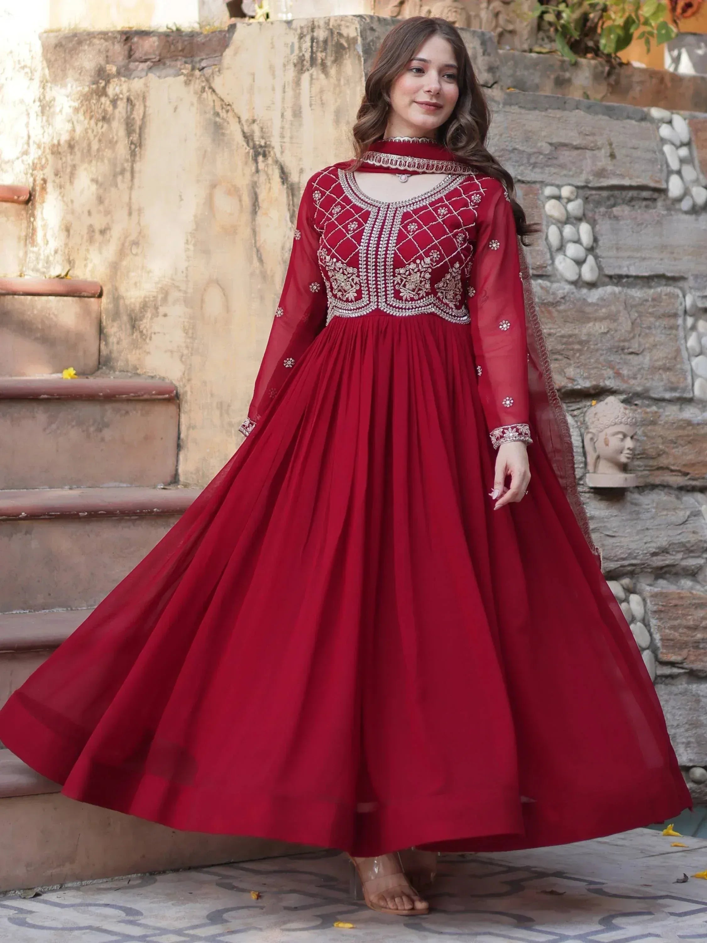 Red embroidered ethnic gown with flared skirt and sheer sleeves, perfect for Indian celebrations