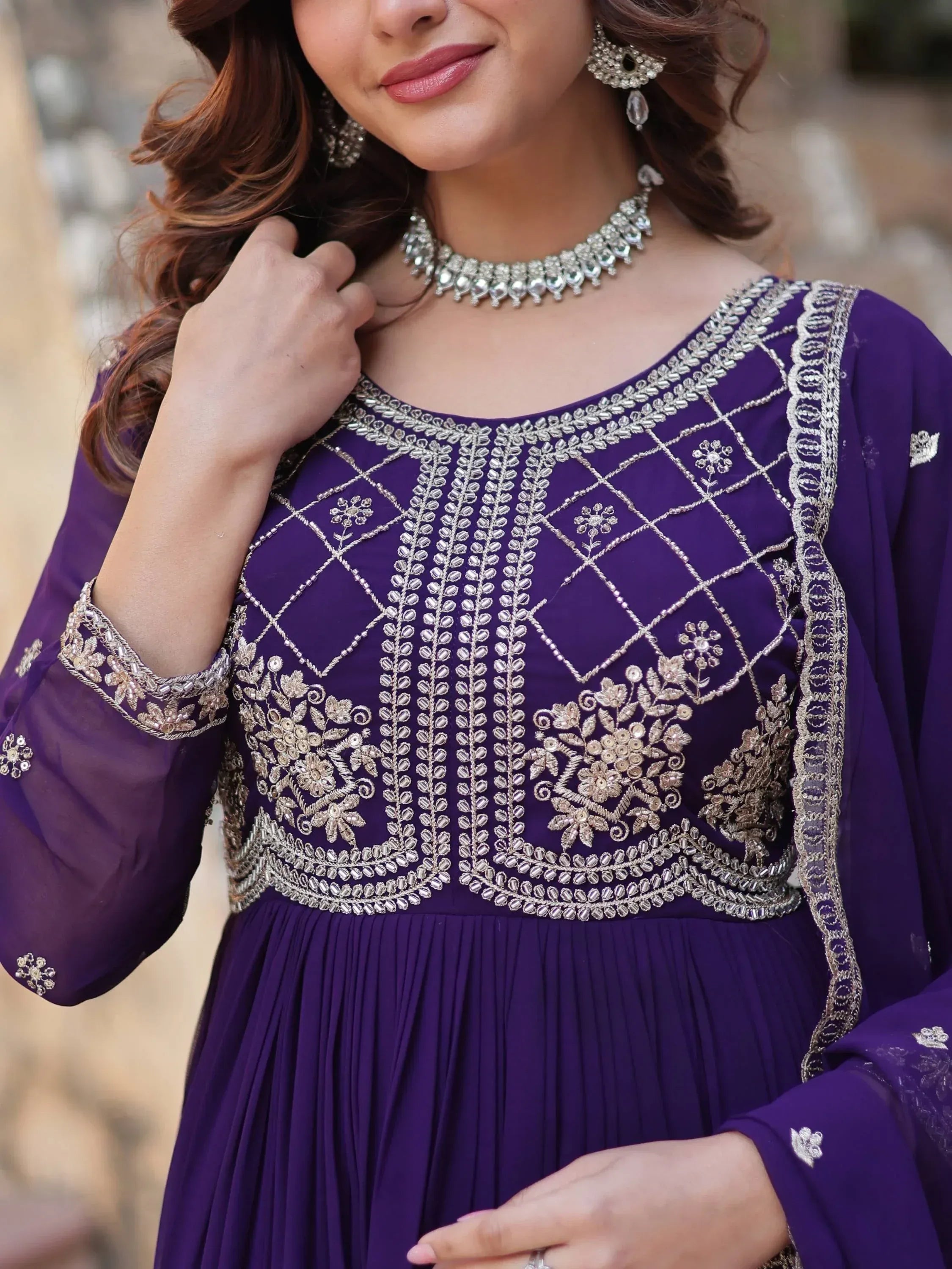 Purple embroidered ethnic gown with silver zari work, perfect for Indian weddings and festive occasions.