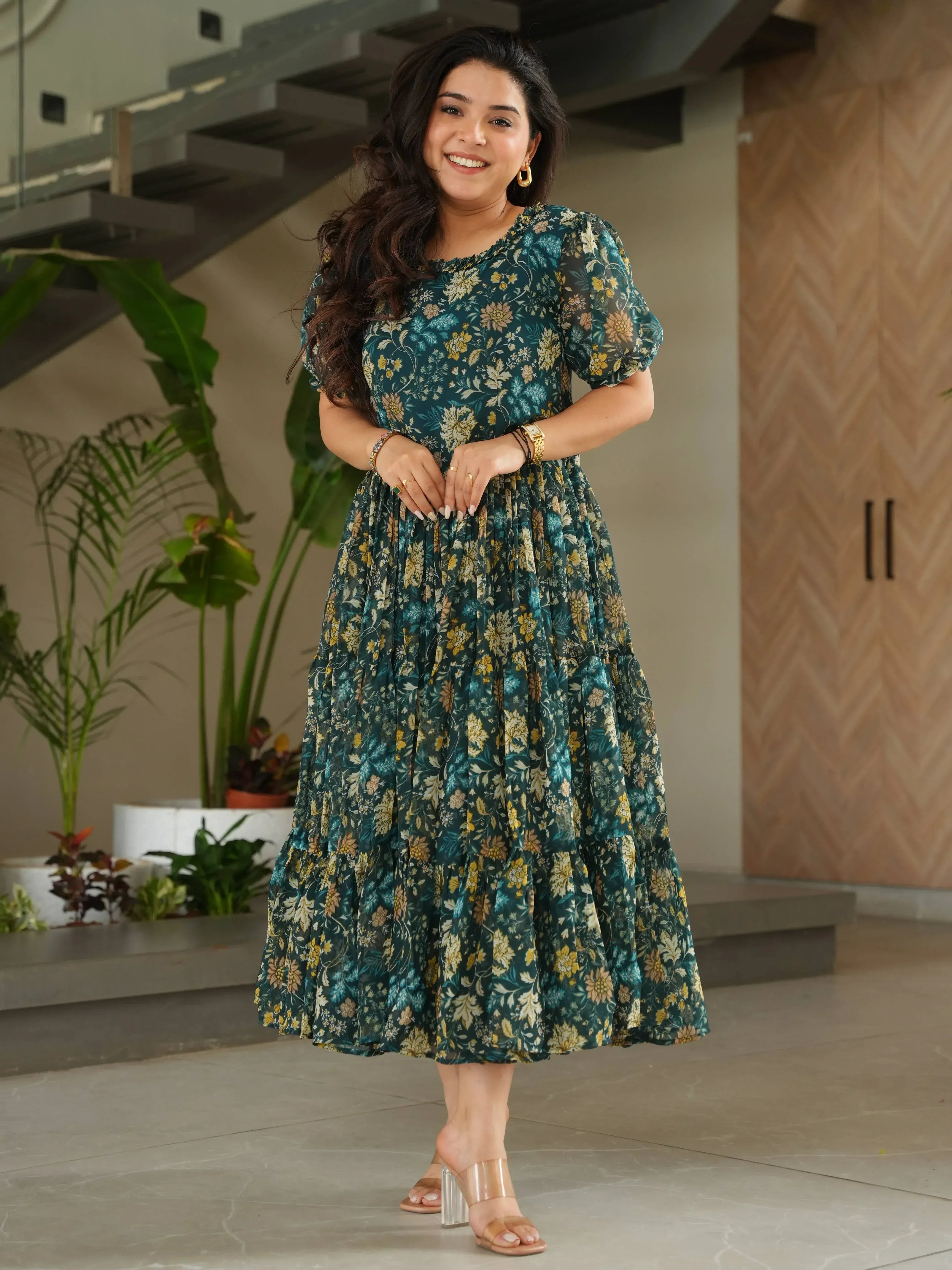 Woman in green floral ethnic gown with puff sleeves, perfect for Indian occasions and festive wear.