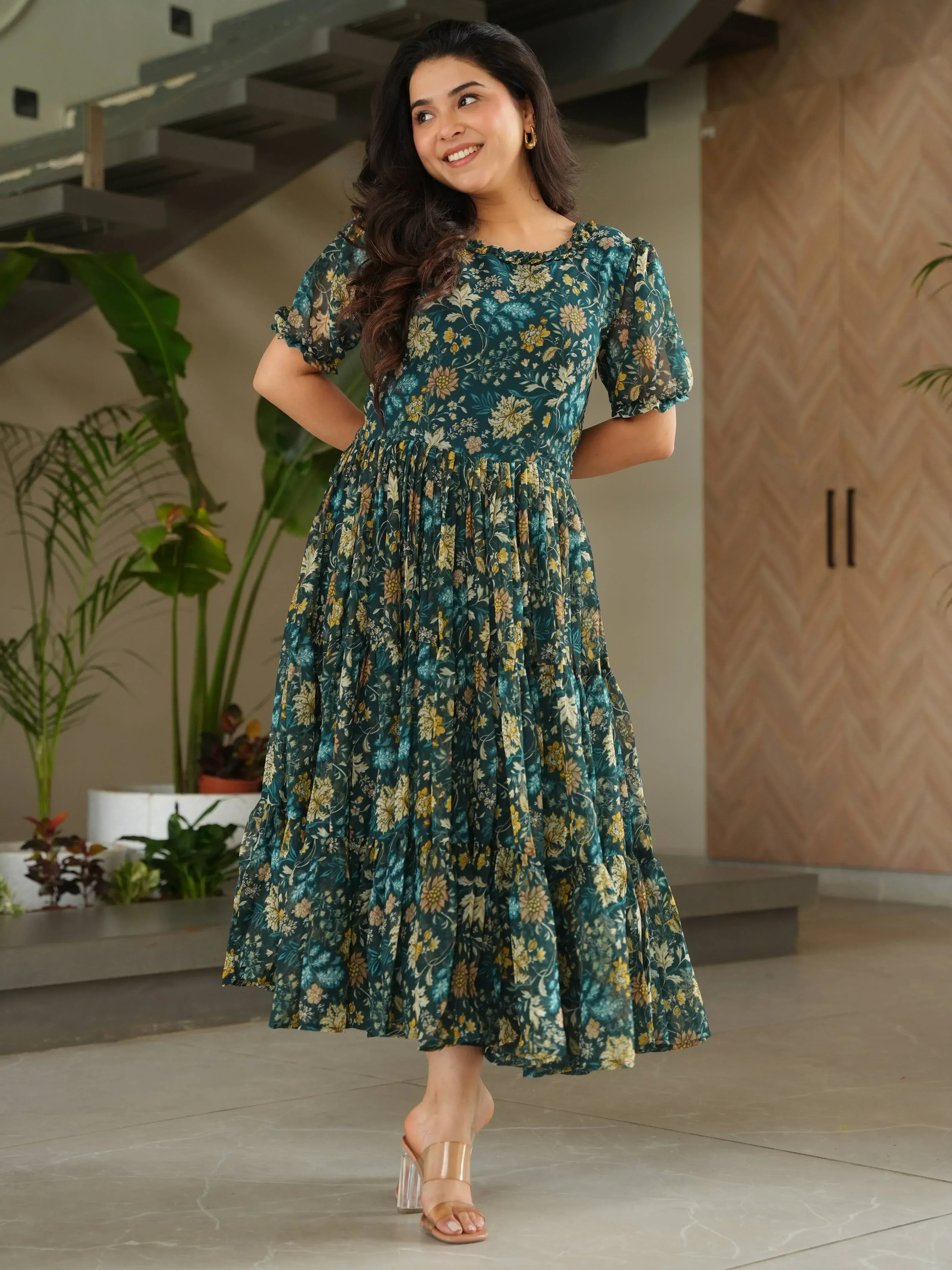Woman in green floral ethnic gown with puff sleeves, perfect for Indian occasions and festive wear.