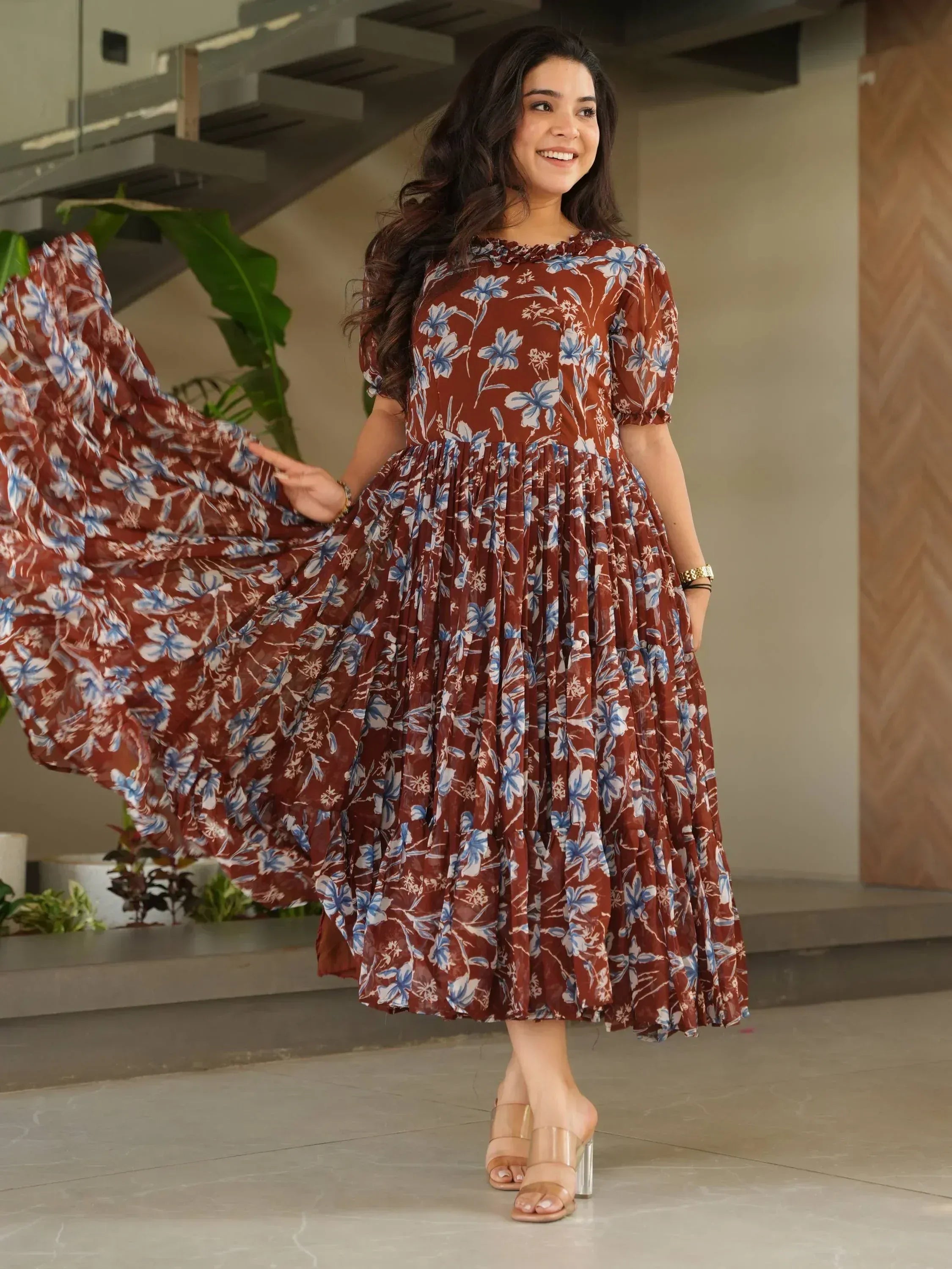Woman in brown floral ethnic gown with puff sleeves, perfect for Indian occasions