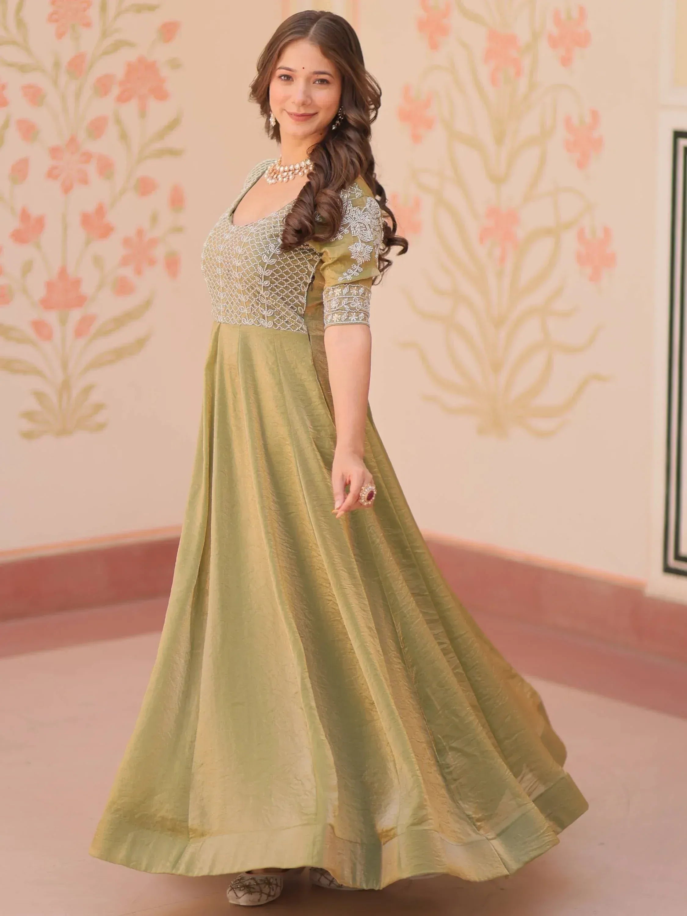 Olive green ethnic gown with silver embroidery, perfect for Indian weddings and festive occasions.