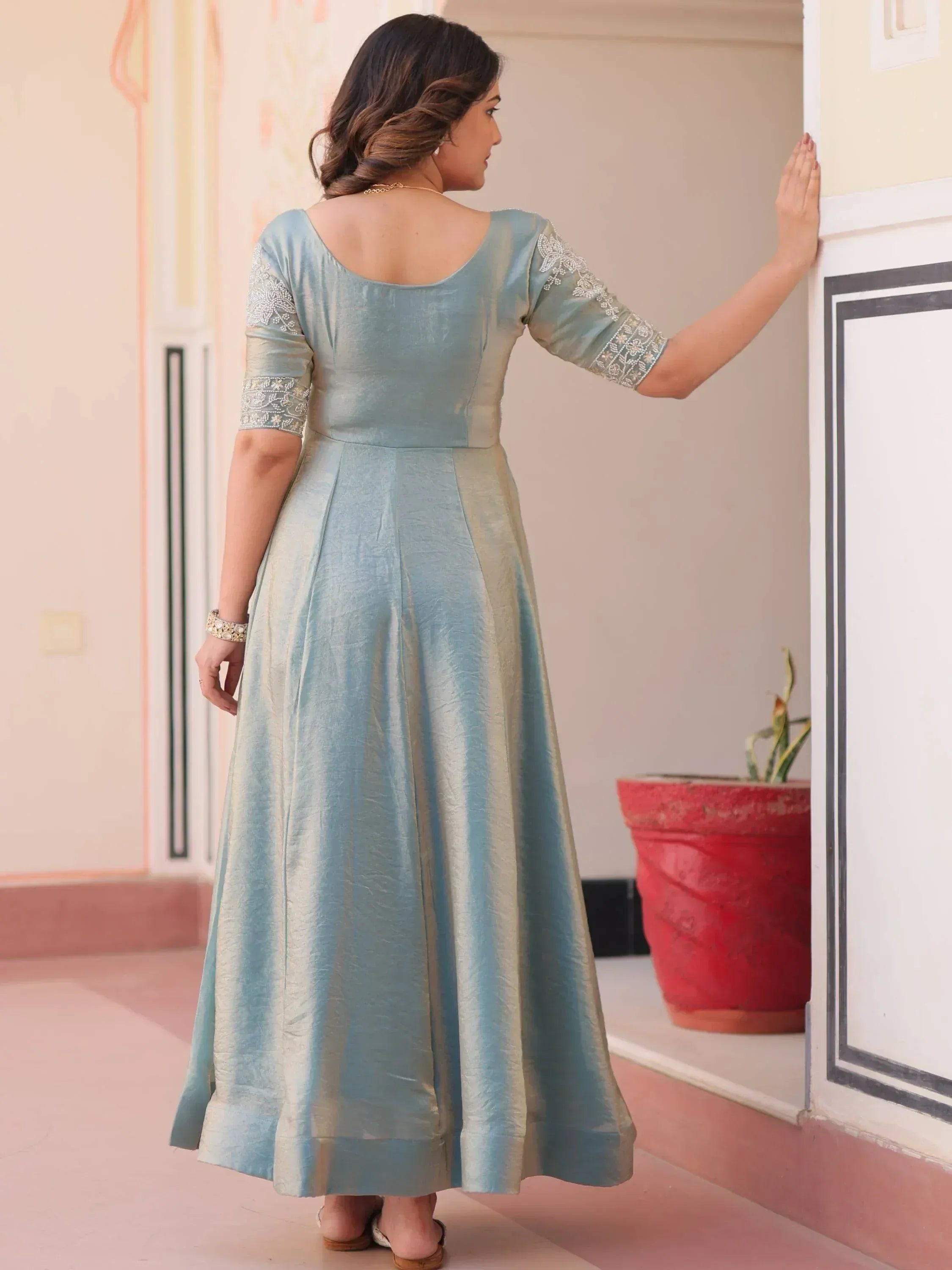 Light blue ethnic gown with embroidered sleeves, back view, perfect for Indian occasions