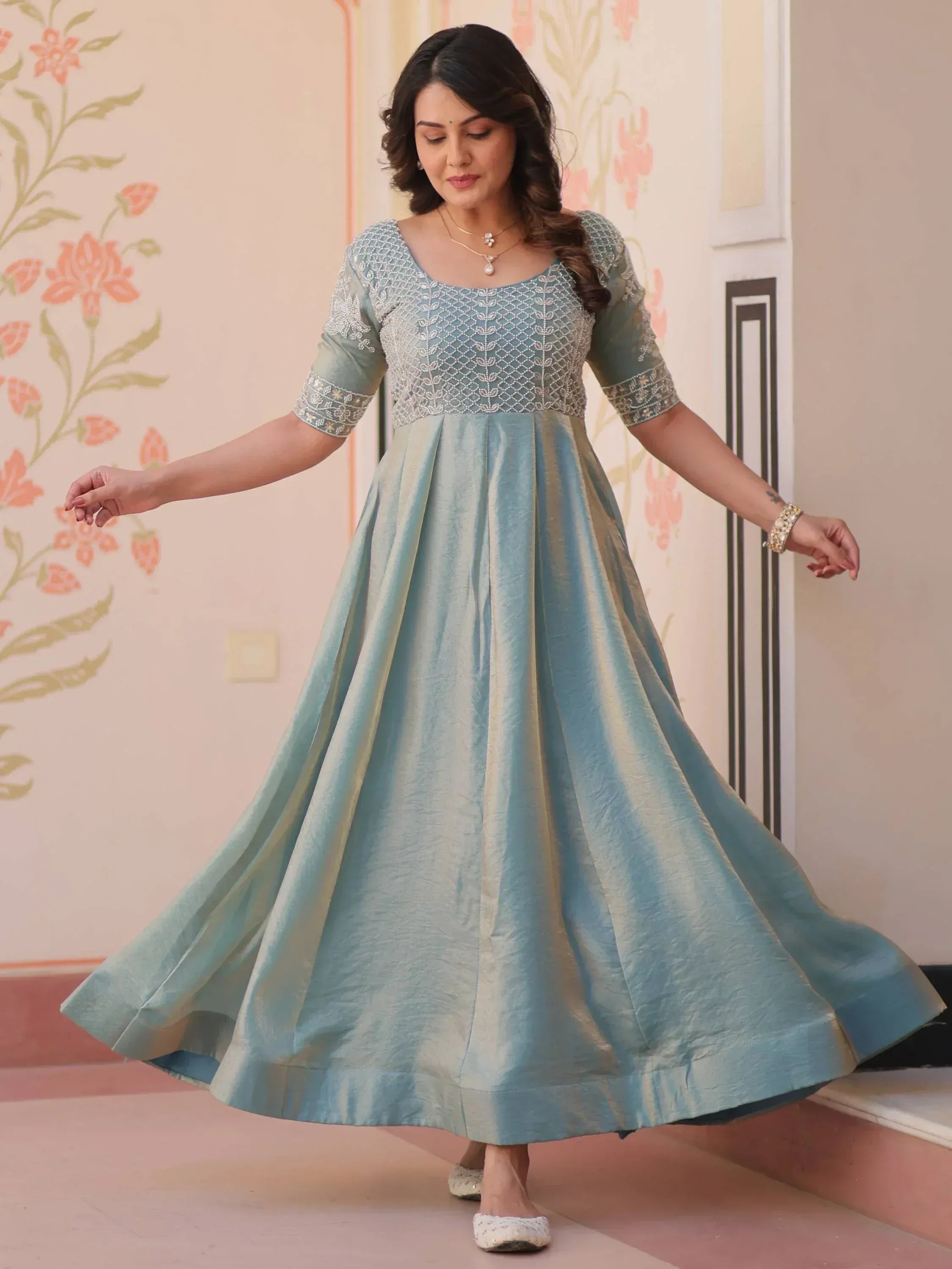 Woman in elegant light blue ethnic gown with embroidered bodice, perfect for Indian occasions