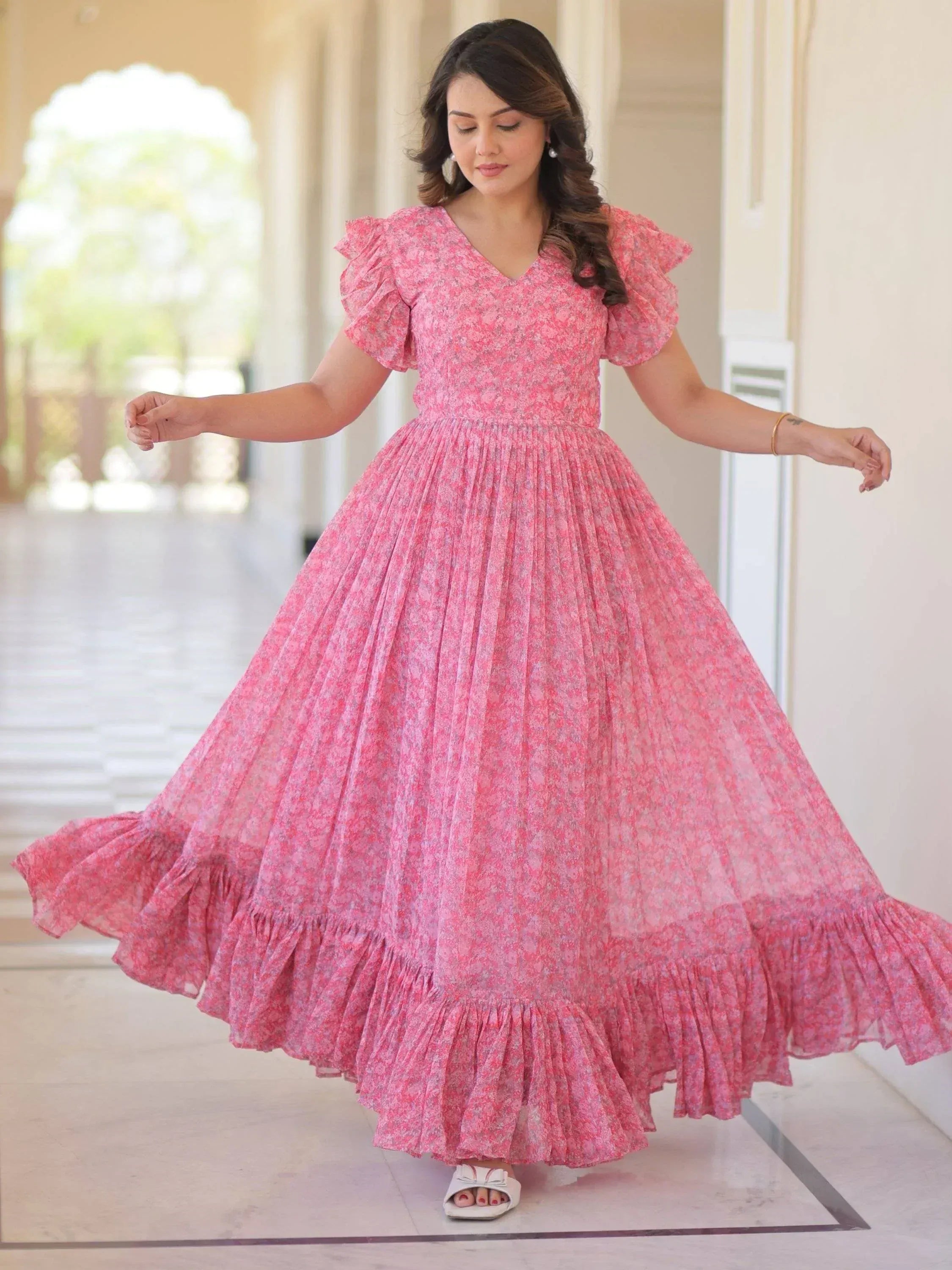 Pink floral ethnic gown with ruffled sleeves and pleated skirt, perfect for Indian occasions