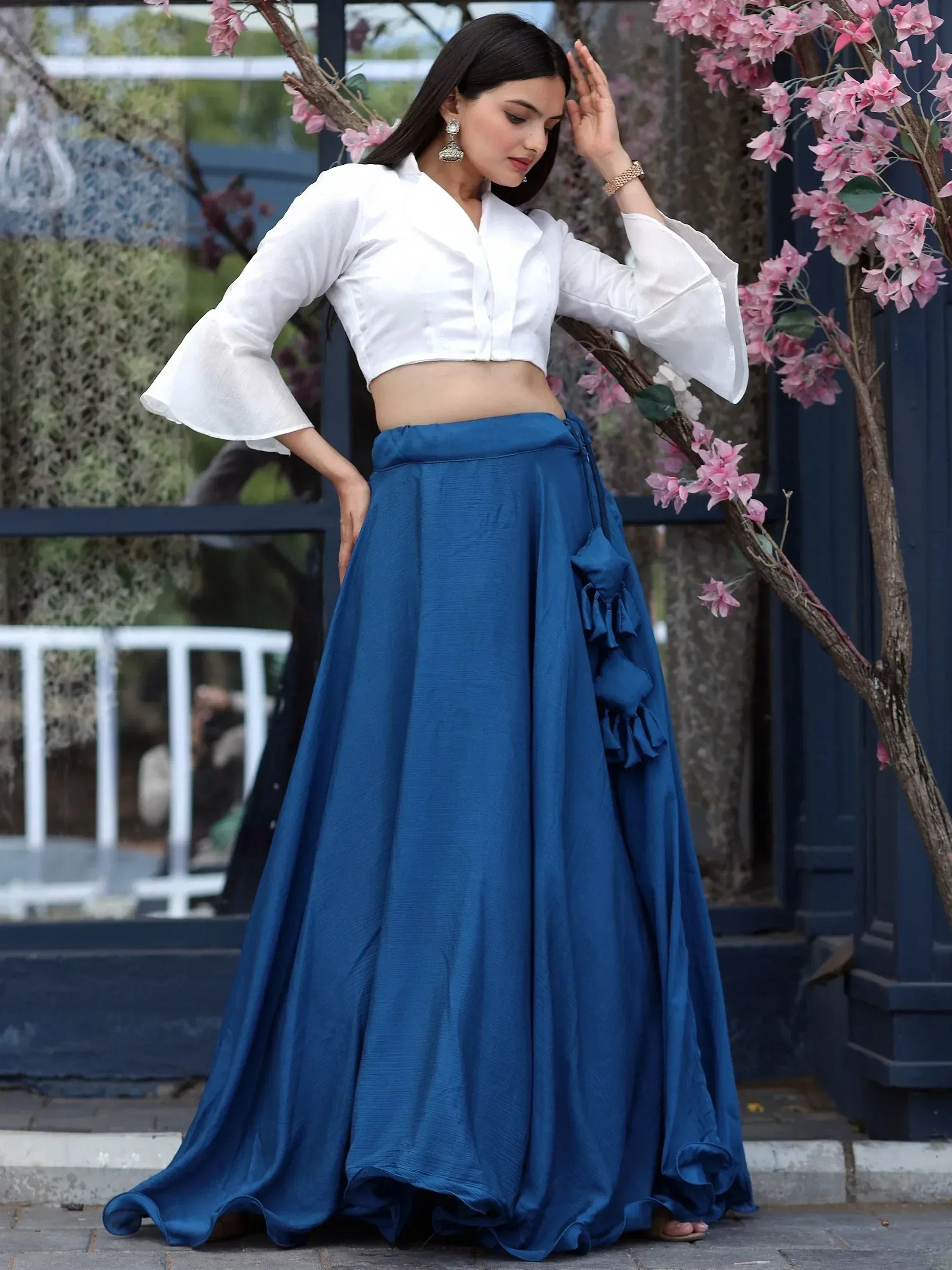 White crop top with bell sleeves paired with royal blue lehenga skirt, perfect for ethnic occasions