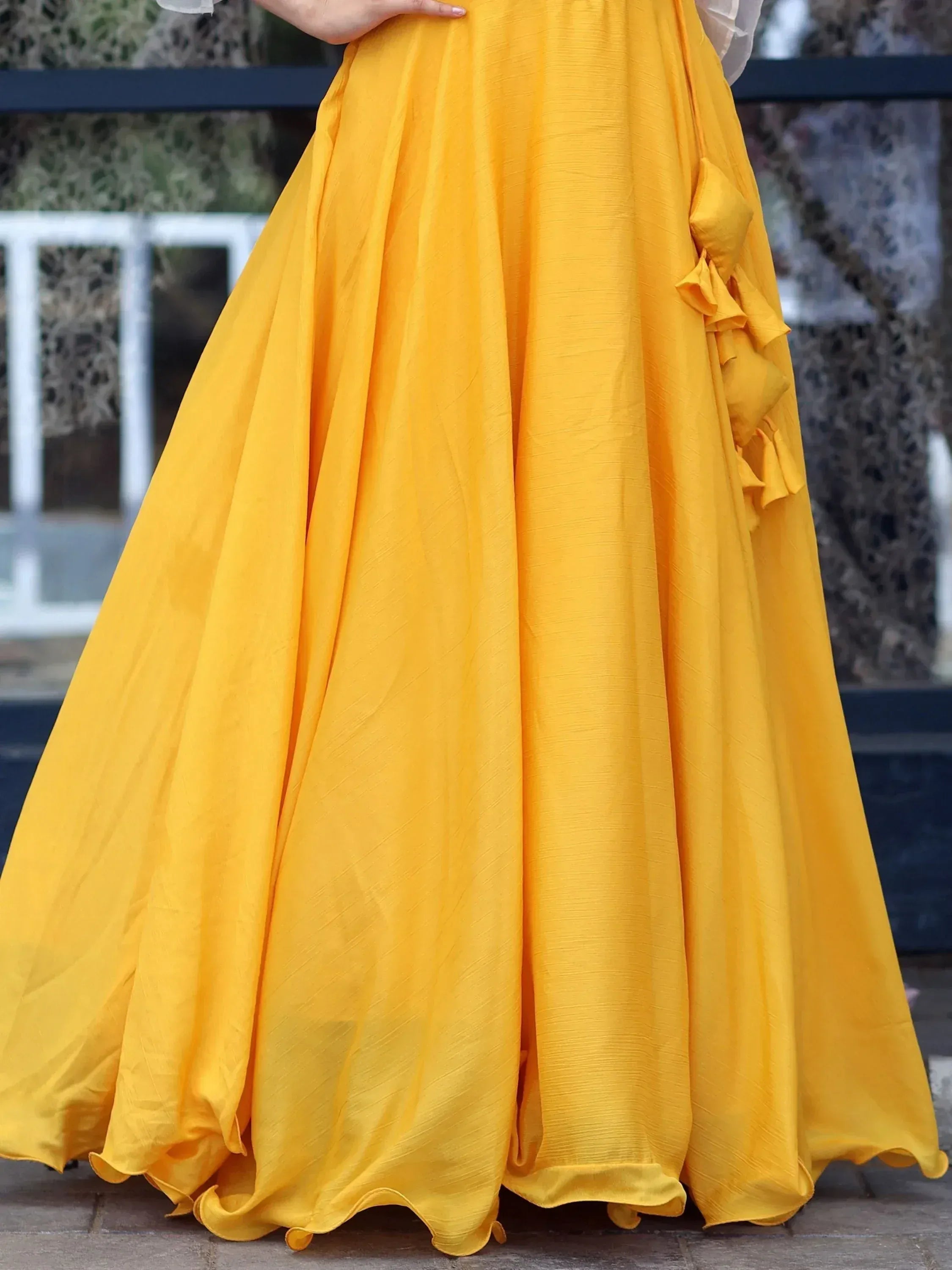 Vibrant yellow ethnic gown with ruffle detailing, perfect for festive occasions and Indian celebrations.