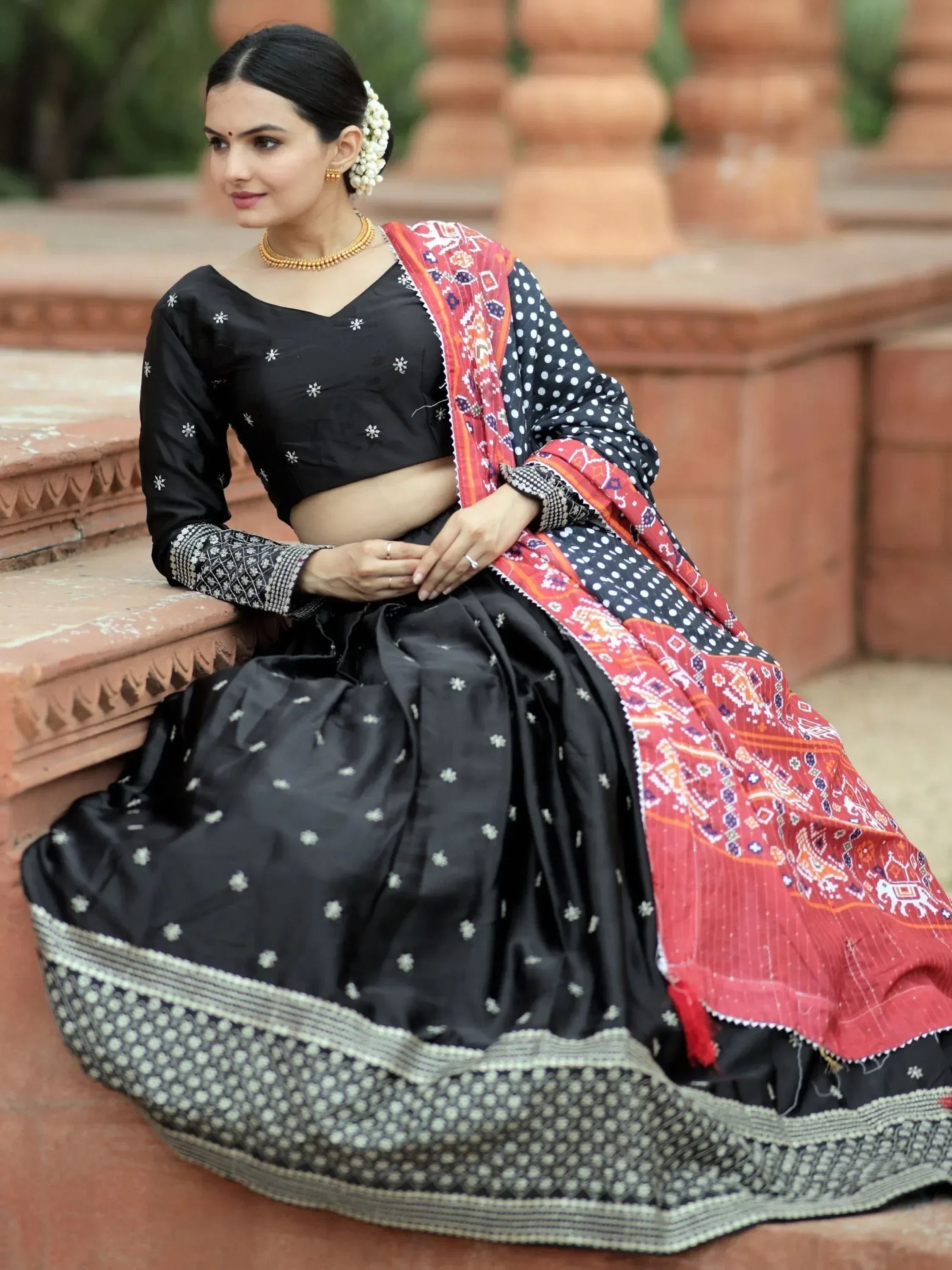 Black embroidered lehenga choli with red printed dupatta, ethnic Indian wear for women