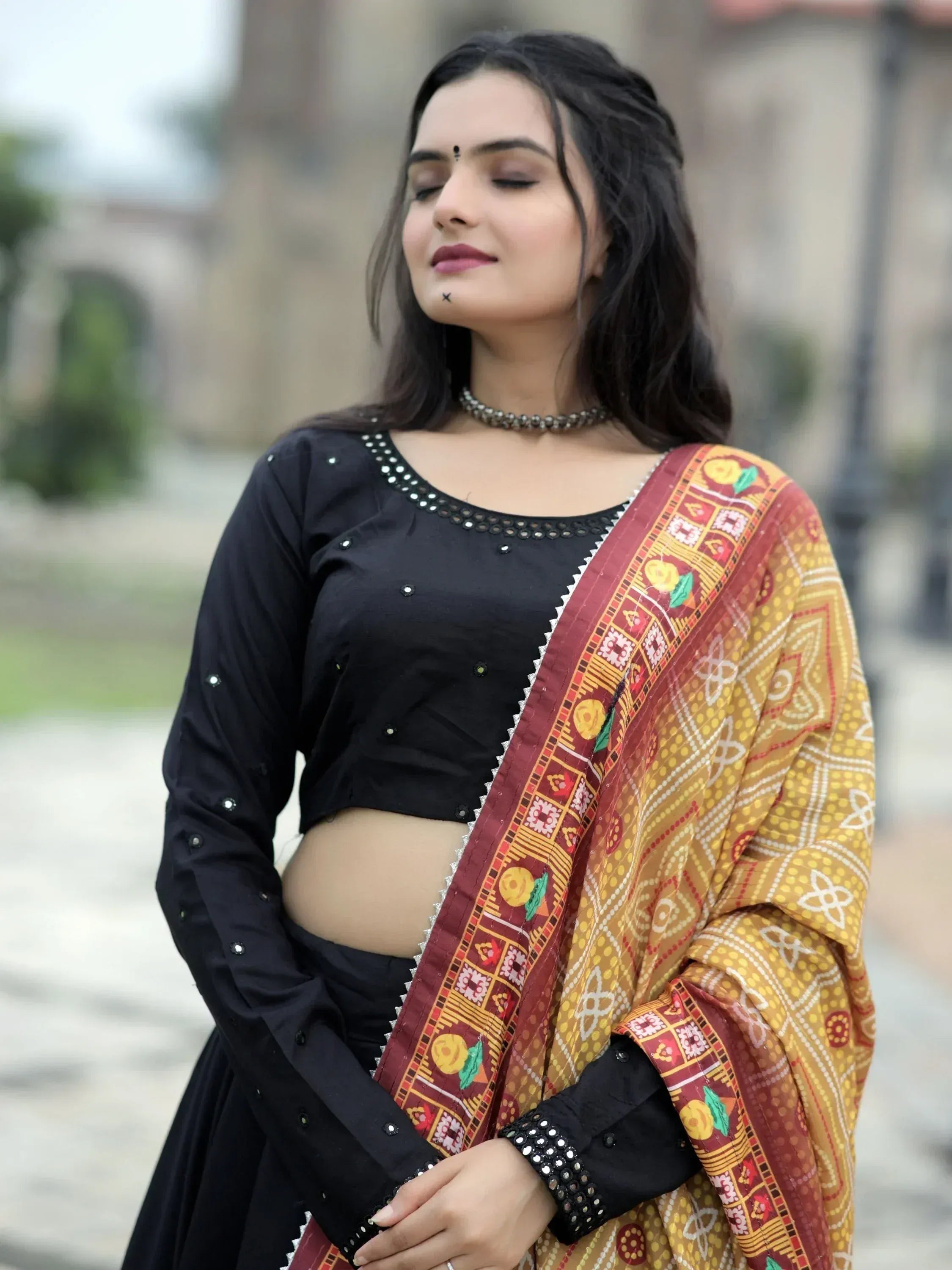 Woman in black embroidered crop top with colorful printed dupatta, Indian ethnic wear