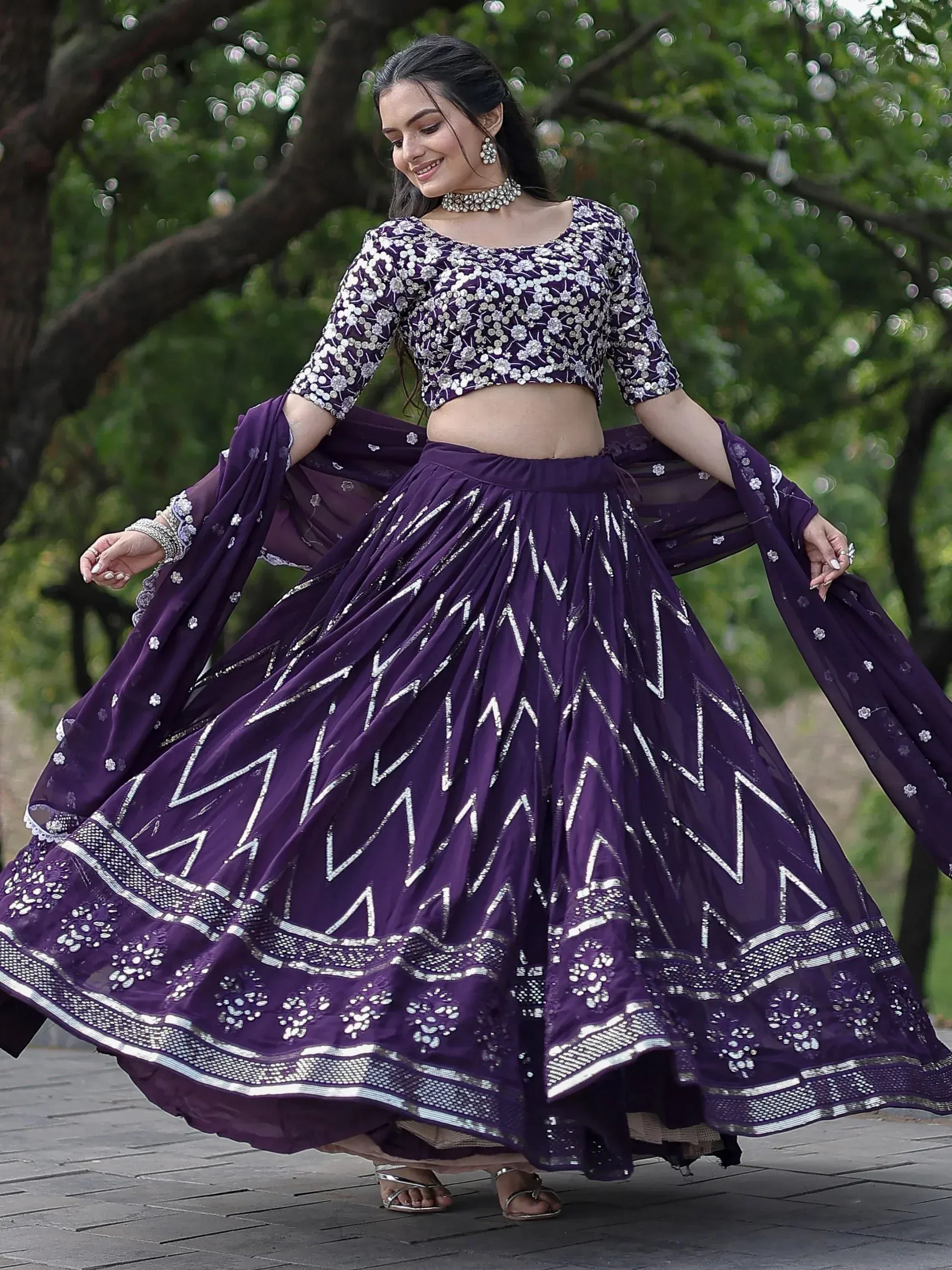 Purple embroidered lehenga choli with floral top and zigzag skirt, perfect for Indian ethnic wear events.