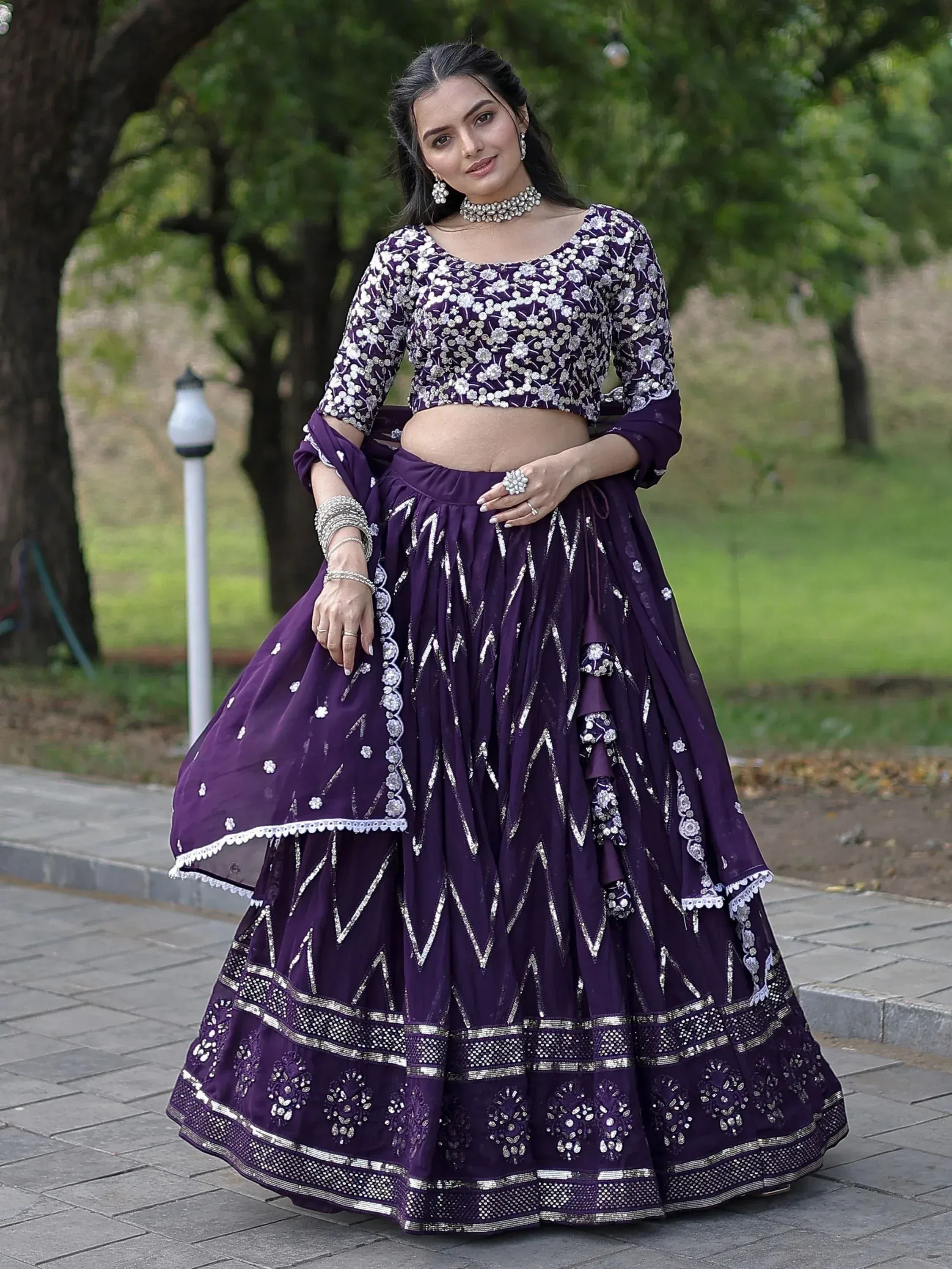 Purple embroidered lehenga choli with floral and geometric designs, perfect for Indian ethnic occasions.
