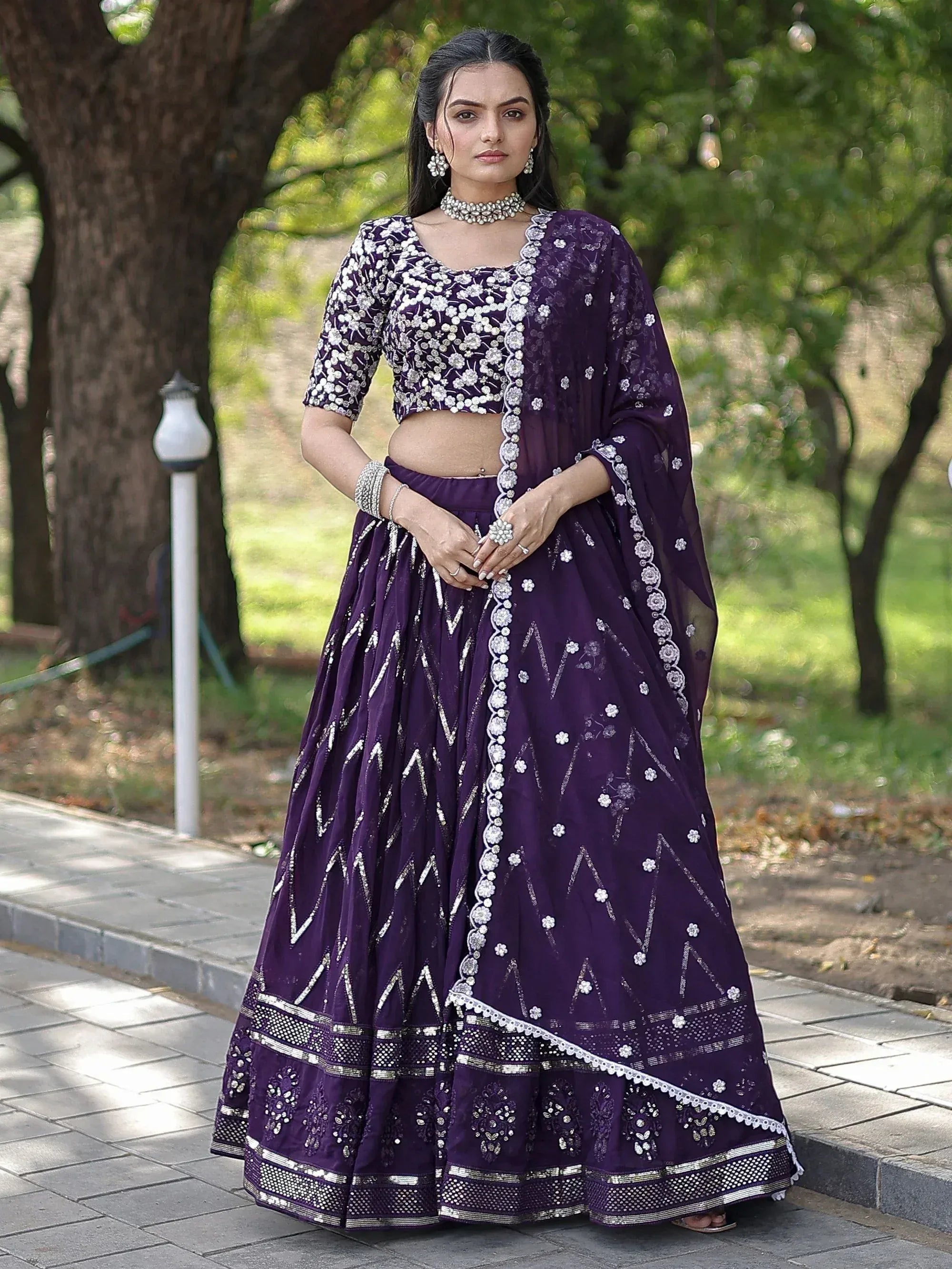 Purple embroidered lehenga choli with floral and geometric patterns, perfect for Indian ethnic wear occasions