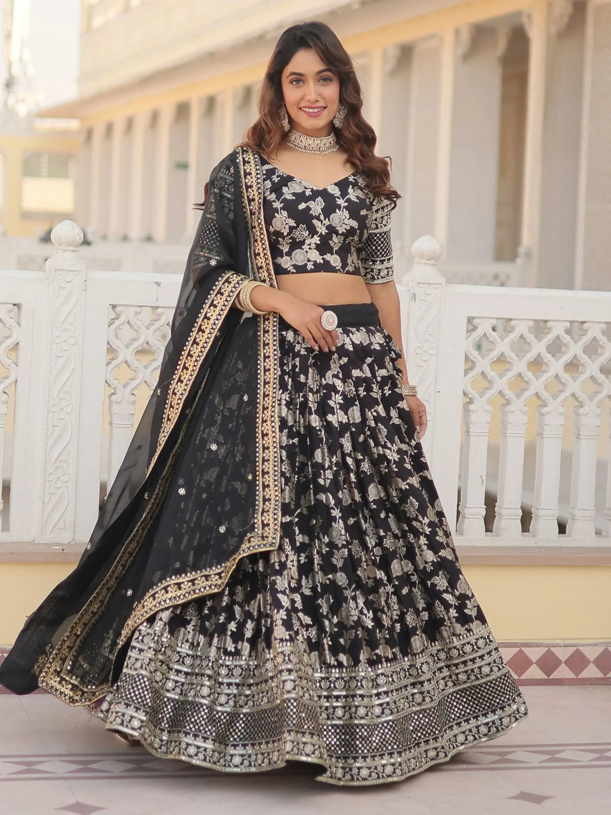 Black and gold embroidered lehenga choli with floral design, perfect for Indian ethnic wear occasions.