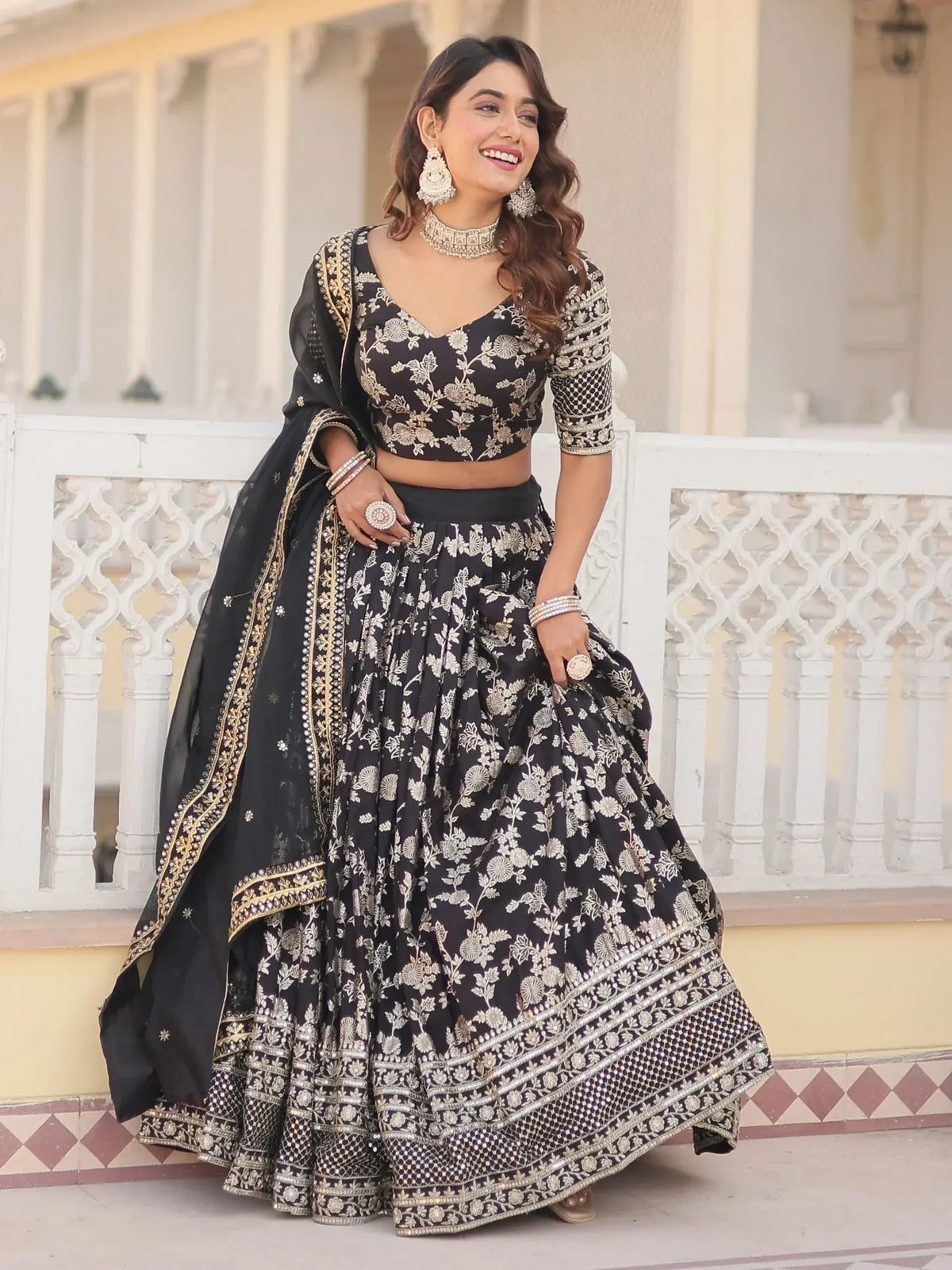 Black and gold embroidered lehenga choli with floral design, perfect for Indian ethnic wear occasions.