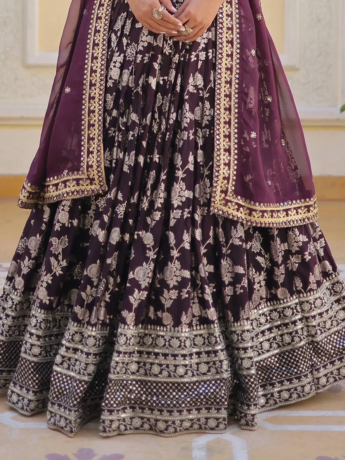 Elegant purple lehenga choli with gold floral embroidery and sequin detailing, perfect for Indian weddings and festivals.