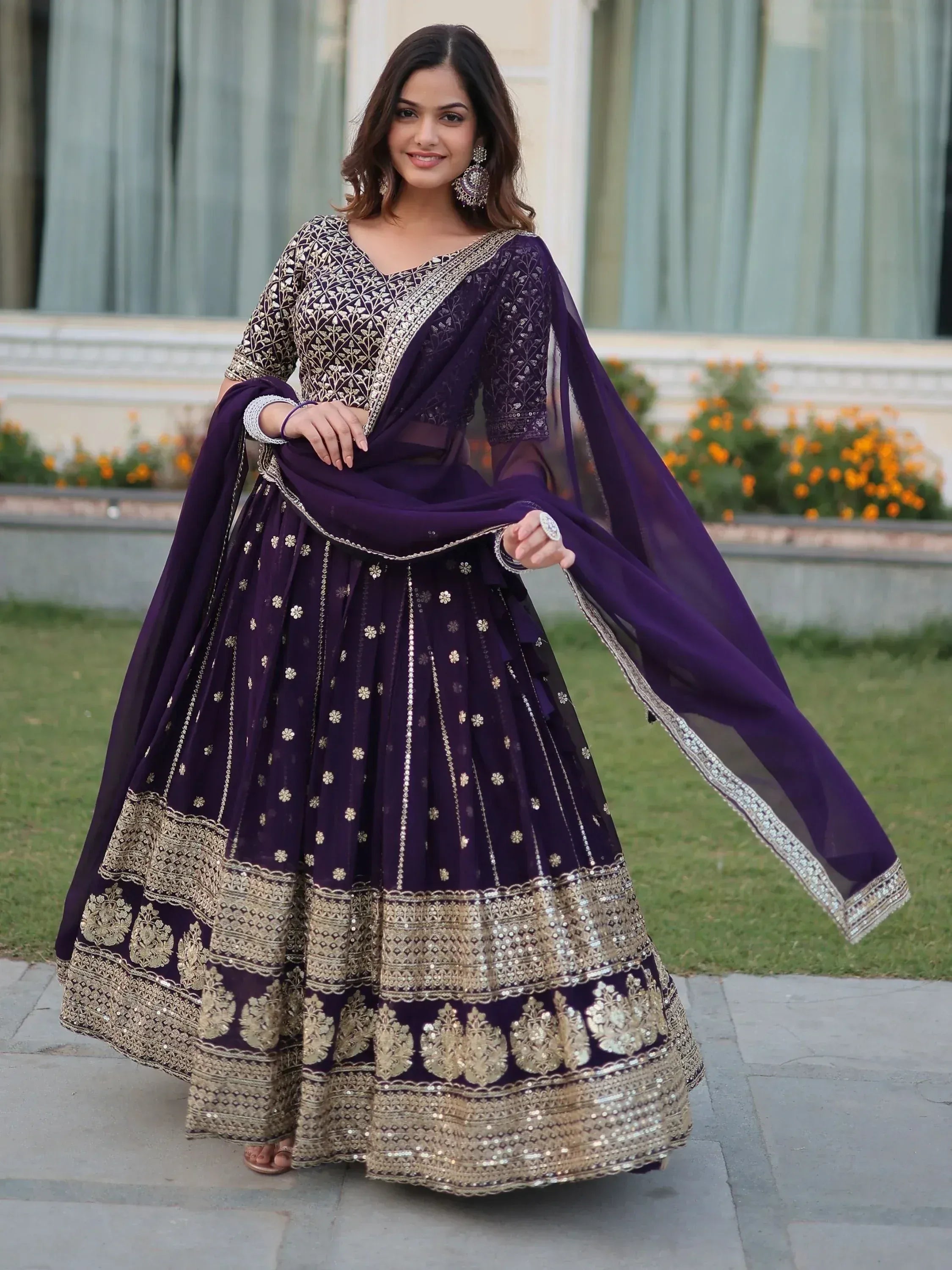 Purple designer lehenga choli with gold embroidery, perfect for Indian weddings and festive occasions.
