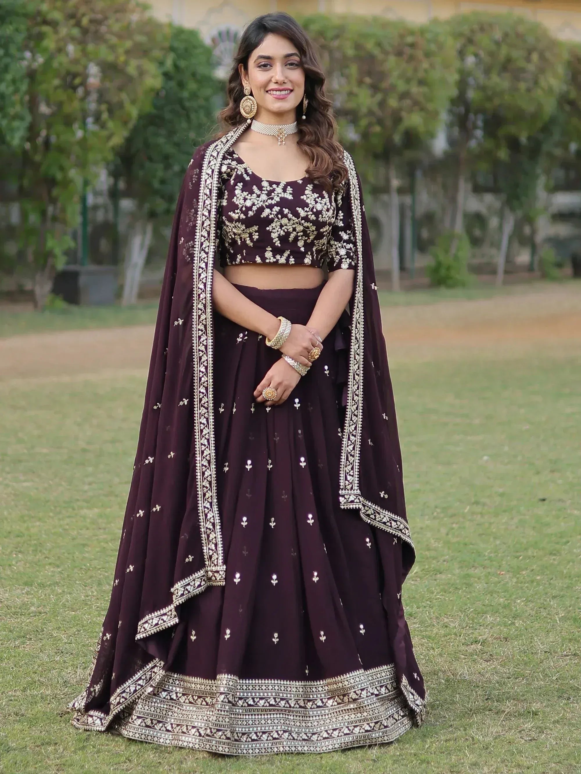 Elegant maroon lehenga choli with gold embroidery, perfect for Indian weddings and festive occasions.