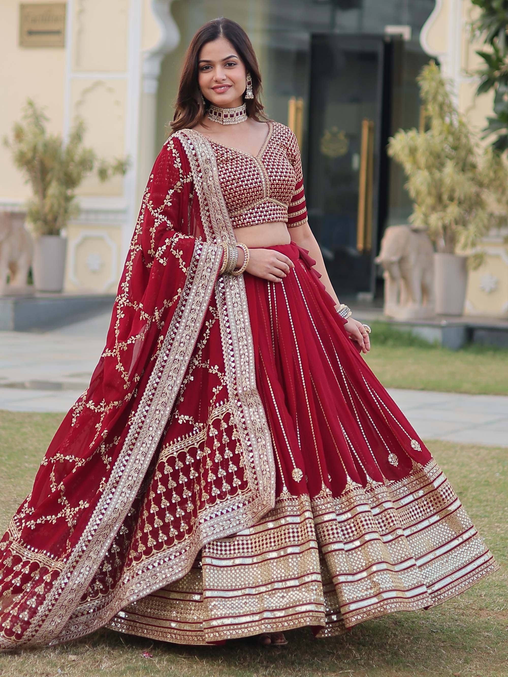 Red embroidered lehenga choli with gold detailing, perfect for Indian weddings and festive occasions.